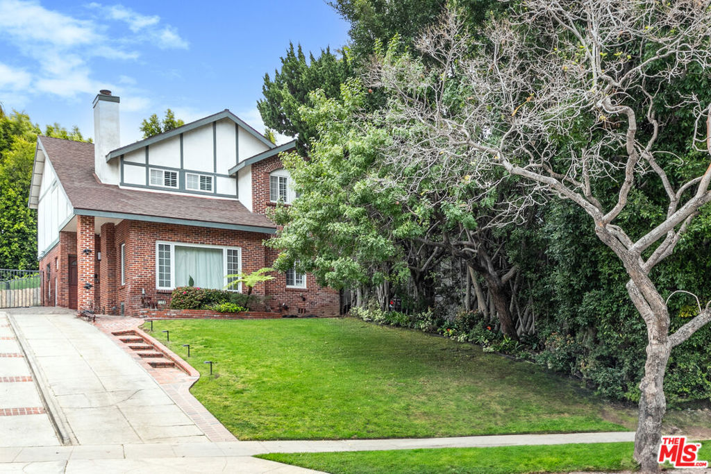 Searching for an elegant Westwood/Century City haven that feels like a private sanctuary? Set atop a gentle knoll, this 5-bedroom, 3-bath fully furnished move-in ready residence delivers just that with its classic two-story brick facade and sprawling front lawn! Inside, discover a formal living room where picture windows, maple hardwood floors, and a sleek marble fireplace create an inviting backdrop for conversation. Host lively celebrations in the dining alcove, complete with a dry bar and glass doors opening to the secluded backyard. The kitchen's handsome wood cabinetry, gleaming granite countertops, Viking 6-burner gas range, and new Viking fridge are ready for any culinary adventure. Relax under soaring ceilings and skylights in the generous primary suite, where a luxurious ensuite offers a serene escape. Upstairs, find plenty of built-in storage alongside your comfortable retreats, while the main-level bonus room adds versatility for overnight guests or remote work. A detached 2-car garage, 6-car driveway, lush landscaping, and a family area wired for sound enhance your experience. With easy access to Fairburn Elementary, UCLA, Westwood Village, Century City mall, Santa Monica, and Beverly Hills, this is urban life at its finest!