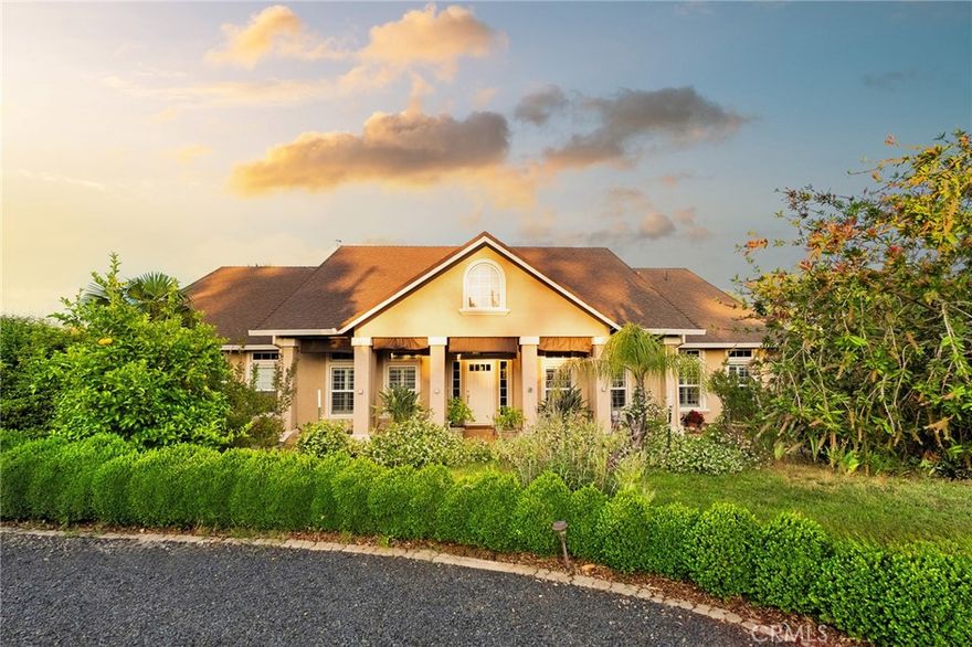 A Rare Luxury Retreat on 1.43 Acres! Welcome to a breathtaking estate that blends sophistication, privacy, and serene living. Set on 1.43 meticulously landscaped acres, the grounds are alive with beauty—towering palms, vibrant blooms, and an abundance of mature fruit trees including citrus, pomegranate, kumquat, persimmon, olive, pear, grapevines, and blueberry bushes. Inside, refined living takes center stage. The formal dining room provides a gracious space for entertaining, while the great room impresses with soaring vaulted ceilings, dramatic windows, and a striking fireplace. The gourmet kitchen features a large center island, granite counters, stainless-steel appliances, and a garden-view breakfast nook, flowing seamlessly into the spacious family room for effortless gatherings. The thoughtful split floor plan offers exceptional comfort, with two primary suites—one with its own fireplace—plus a private guest suite, ideal for visitors or multi-generational living. Each additional bedroom is complete with its own bathroom, while elegant plantation shutters enhance the timeless style throughout. Outdoors, enjoy an expansive covered patio overlooking lush, tropical-inspired gardens. This estate is equipped with a state-of-the-art solar array paired with battery backup, dramatically reducing energy costs while providing reliable power security and independence. Ample RV parking ensures your recreational needs are met with ease. Perfectly located just minutes from Lake Oroville’s Lime Saddle Marina, you’ll have premier boating, fishing, and water recreation at your doorstep, along with quick access to Highway 70 for easy commuting. This estate is a rare blend of craftsmanship, natural beauty, and modern luxury—offering a lifestyle of tranquility, elegance, and energy-smart living.