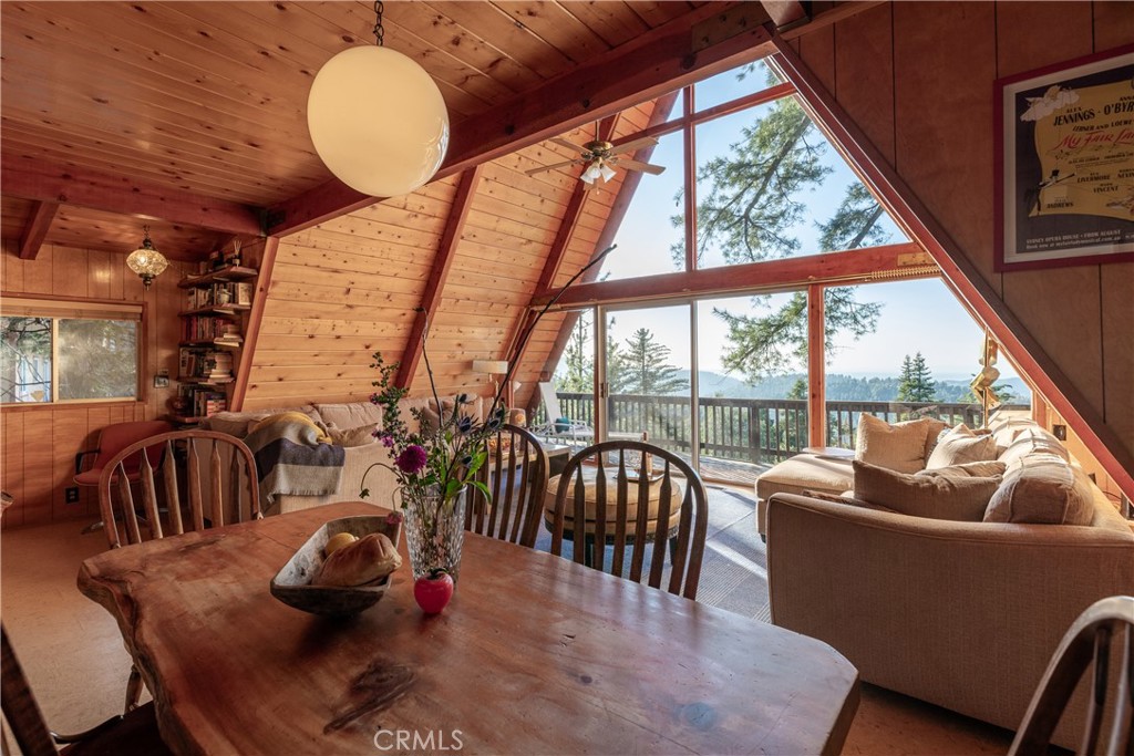 Imagine an impeccably maintained mid-century A-frame cabin, on the market for only the second time in 60 years, with breathtaking jetliner views of the high desert and surrounding mountains: all set on over 1/4 acre of land. Built in 1964 and perched on a mountainside along one of Crestline's most desirable streets, this architectural gem spans five unique levels and sits on three private, view-filled lots. The fully furnished home blends timeless design with modern comfort, featuring solid oak flooring on the main level, original pine floors in the loft, and a custom kitchen and bathrooms adorned with porcelain tile. A flowing floor plan opens onto multiple outdoor living spaces, including a stunning wraparound deck ideal for sunset views, spacious patios and terraces, and a private hot tub nestled among towering pines and natural rock outcroppings. The property also includes a self-contained one-bedroom apartment with its own entrance, making it perfect for multigenerational living or income potential—it currently operates as a successful, county-permitted short-term rental. Additional amenities include a wheelchair-accessible entry and living areas, multiple indoor and outdoor gathering areas and three off-street parking spots. Whether you're seeking a peaceful mountain retreat, a profitable investment, or both, this A-frame offers a rare opportunity just 90 minutes from Los Angeles.