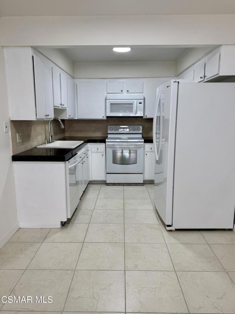 Updated 2-bedroom, 2-bathroom condo with new vinyl wood flooring, and new interior paint throughout. The kitchen opens to a large family room with a cozy fireplace. The home includes two spacious bedrooms, and comes with washer/dryer and refrigerator. Quiet complex in central area of Simi with community pool. Includes two parking spaces, one covered.