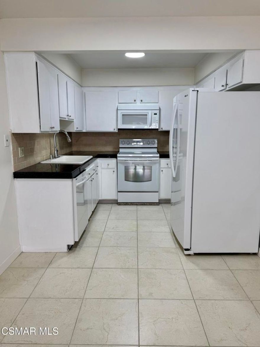 Updated 2-bedroom, 2-bathroom condo with new vinyl wood flooring, and new interior paint throughout. The kitchen opens to a large family room with a cozy fireplace. The home includes two spacious bedrooms, and comes with washer/dryer and refrigerator. Quiet complex in central area of Simi with community pool. Includes two parking spaces, one covered.
