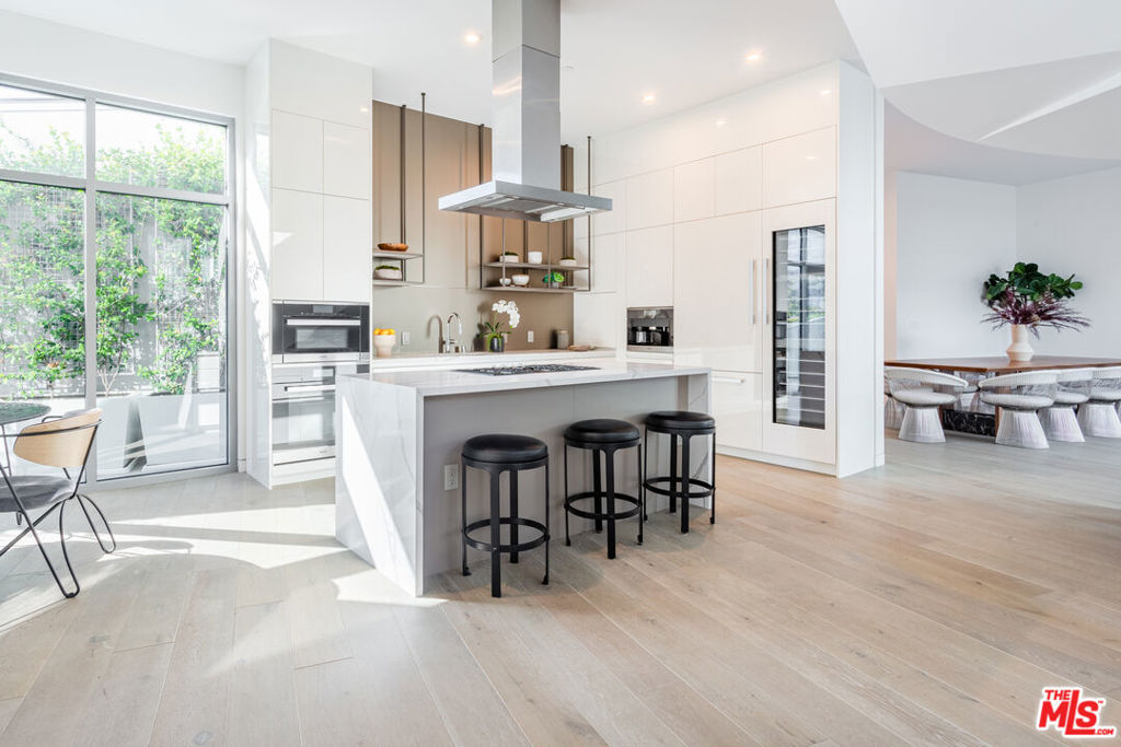 This rare duplex penthouse at Gardenhouse Beverly Hills offers a truly elevated lifestyle, blending modern luxury with the privacy of a single-family home. Spanning two expansive levels with direct access from a private in-unit elevator, this residence is designed for both grand entertaining and quiet retreat. Walls of glass bathe the interiors in natural sunlight and open to multiple outdoor terraces, including a breakfast terrace, a courtyard terrace, and a private bedroom terraceperfect for al fresco dining or enjoying serene hillside views. The lower level features a stunning open-concept design with a great room, formal dining area, and a chef's kitchen equipped with premium appliances, custom cabinetry, and an oversized island. Upstairs, the primary suite is a sanctuary with its own lounge, spa-inspired bath with a wet room, and an expansive walk-in closet. Two additional bedrooms, each with en-suite baths, provide ample space for family or guests. Combining the scale and sophistication of an estate with the security and services of a boutique building, this residence places you in the heart of Beverly Hillsjust moments from world-class dining, luxury shopping, and cultural attractions. Gardenhouse redefines exclusive living, offering a one-of-a-kind opportunity in one of the city's most coveted addresses.