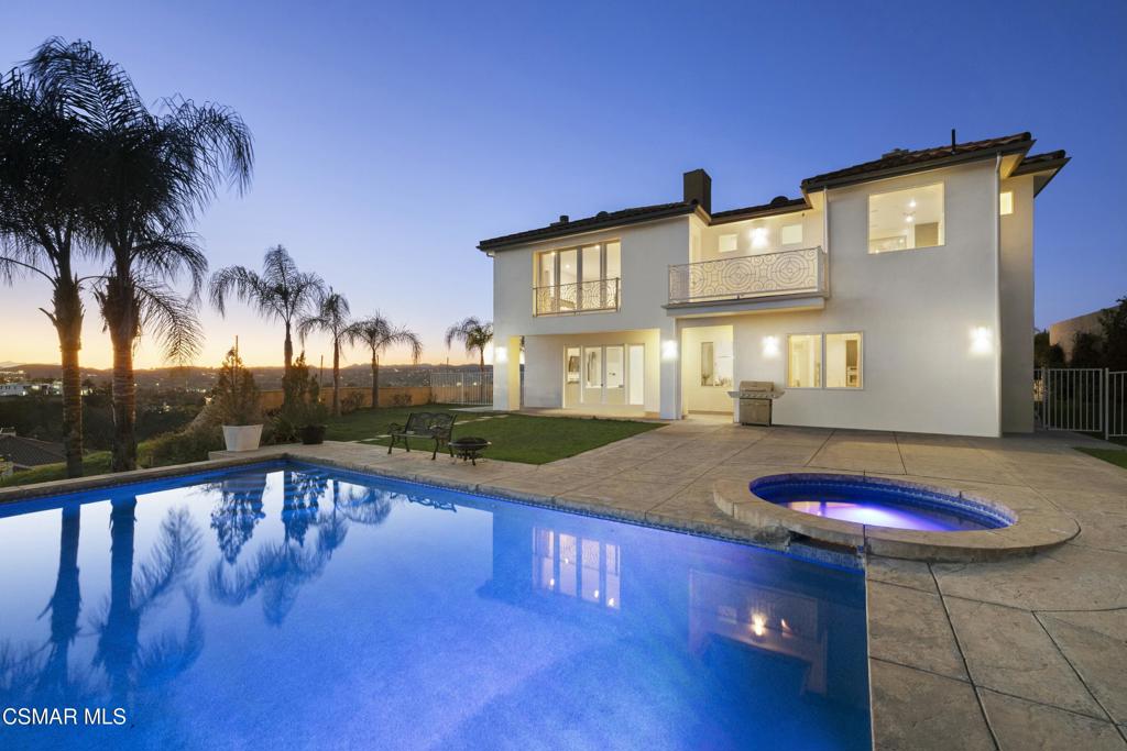 Welcome to this pristine, gated and very private estate with beautiful panoramic views for days! Nestled in Woodland Hills, south of Ventura Blvd, this is an entertainer's dream encompassing both indoor & outdoor living spaces with nearly 5,300 sqft, 4 bedrooms and 5 baths. You are welcomed into the living areas with lots of natural light, cathedral ceilings, and a cozy fireplace. The gourmet eat-in kitchen features a luxurious center island, large double refrigerator /freezer, walk-in pantry, plenty of cabinets for storage, and a wine refrigerator (add'l wine storage room in another area). All bedrooms are very spacious and offer plenty of natural light too. The house is equipped with a smart lighting system controlled by 3 wall-mounted iPads, with the family room, entertainment, and bedrooms all having surround sound in the ceiling. Yes, don't miss the incredible entertainment room with surround sound, four fireplaces, and an elevator! Enjoy free time in the private backyard with magnificent 180-degree views framing a sparkling infinity pool. This luxury home feels like a resort! Relax in the custom gazebo, equipped with a built-in cook center, fountain, and citrus trees. Plenty of parking in the gated driveway. plus the total garage space is 1,072 sf which includes a 3-car garage of 683 sf, a wine storage area of 230 sf, an elevator, and a central vacuum system. Don't miss the opportunity to make this Mediterranean Villa yours!!