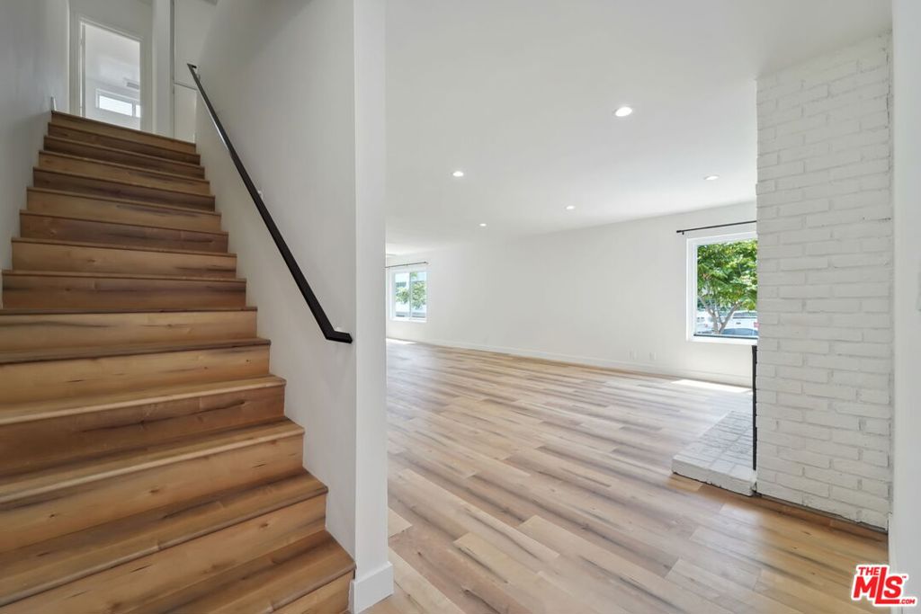 Renovated two story, three bed two and a half bath apartment north of Wilshire. Large living room with recessed lighting, dining area, kitchen with updated appliances, quartz countertops, new shaker cabinets and half bath. Second floor, includes primary bedroom with large closet and en suite bathroom, two additional bedrooms and another fully updated bathroom. New flooring throughout. The apartment also has an outdoor balcony off the kitchen. Washer and dryer hookups in 3rd bathroom. Great school district and location less than a block from Whole Foods, two blocks from Trader Joe's and half a mile from Erewhon. Easy access to beach and freeways. Available for immediate move in.