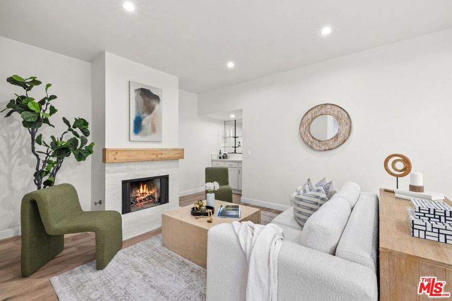 Presenting a fabulous, prime Studio City end-unit townhouse with treetop views, positioned away from the street in a desirable complex with well-manicured landscaping. Designed with entertaining top of mind, the living room includes a mini bar, stylish wood-burning fireplace, and sliding door to the balcony to provide an ideal indoor-outdoor vibe. Wide-plank floors continue to the dining area as plantation shutters add charm and elegance to the spaces. The adjacent eat-in kitchen has copious bright cabinetry, granite countertops/backsplash, and plenty of preparation space. Both bedrooms are en-suite, each with private balcony access and a walk-in closet, and the primary bathroom includes a dual-sink vanity. Side-by-side laundry hookups are found in unit, and there is even a private two-car garage, a rarity indeed! Just down the street is Beeman Park and the Studio City Recreation Center's picnic tables, tennis courts, basketball hoops, baseball diamonds, and playground shaded by giant California oaks. The home is also close to parks, award-winning schools, major freeways, the LA River greenway trail, and the restaurants along Ventura Boulevard, all just moments to Universal City Walk and The Shops at Sportsmen's Lodge, anchored by Erewhon and Equinox. Welcome home!