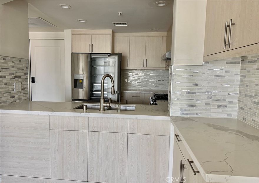 Modern 1-bedroom, 1-bath condo located in a secured 24-hour gated community in the heart of Downtown Long Beach. Featuring approximately 910 sqft of stylish living space with upgraded wood flooring and an open floor plan filled with natural light. The kitchen is beautifully appointed with custom cabinets, stainless steel appliances, and a large island that flows seamlessly into the living and dining areas—perfect for both everyday comfort and entertaining. Enjoy peaceful garden views from your private balcony. Additional highlights include an individual laundry room, all appliances included with the home, and a assigned parking spaces in a secured underground garage. Enjoy premium community amenities including a fitness center, sky garden with BBQ and lounge areas, and beautifully landscaped courtyards. Ideally located just a 5-minute drive from the Downtown Long Beach waterfront, The Pike, Aquarium of the Pacific, and Convention Center, with convenient access to shopping, dining, and major freeways. This modern home combines comfort, convenience, and a vibrant urban lifestyle—all in one exceptional location.