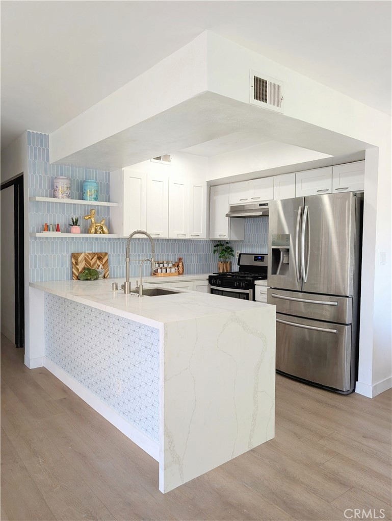 Welcome to this charming upstairs corner end unit. This updated 2 bedroom and 1 bathroom home offers an open floor plan with plenty of natural light, waterproof luxury vinyl plank flooring, recessed lighting and central AC and heating. The kitchen features white calacatta quartz with a waterfall edge, brushed stainless steel appliances and fixtures, shaker cabinets and reverse osmosis water filter system under the sink. The bathroom features quartz countertop, large marble like tiles and brushed gold fixtures. Home has in unit laundry room and an extra closet in the hallway for extra storage. Parking is in your own detached tandem 2 car garage in the gated community that offers swimming pool and spa, picnic area and playground. Low HOA covers landscaping, water, trash, common area maintenance and security that patrols the community in the evening to early morning. Located next to the 710 freeway and close to the 10, 60 and 5 freeways, you're just minutes from downtown LA, restaurants, shops and CSULA.