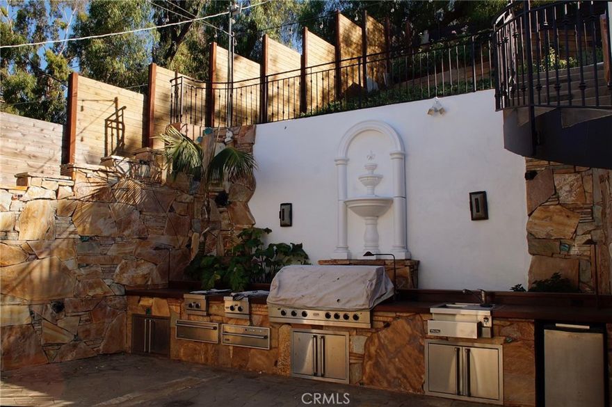 Located South of the Boulevard in one of Woodland Hills' most desirable neighborhoods, this property has it all. It is a spacious and freshly painted 5-bedroom home offers quality finishes, unique spaces, and scenic Valley views from the upper levels and backyard. The main level features three bedrooms, while upstairs includes the primary suite, an additional bedroom, two flexible bonus rooms, great for a gym, media room, playroom, office, guest space, or extra storage, and a walk-in wine cellar. The home also features a huge living room, perfect for entertaining, along with a kitchen equipped with high-end appliances. Outside, the private backyard includes a built-in BBQ and offers plenty of space for relaxing or hosting. Additional highlights include plenty of storage throughout and a three-car garage. Move-in ready with fresh interior and exterior paint, this is a rare lease opportunity in a prime Woodland Hills location, just minutes from Ventura Boulevard’s dining, shopping, and top-rated schools.