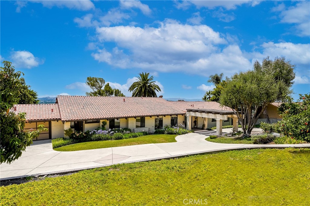 Elegant Spanish-Style Estate with Sweeping Views, Lush Grounds & Private ADU in Glendora
Nestled in the prestigious foothills of Glendora, this spectacular Spanish-style estate blends timeless architecture with modern luxury across a beautifully landscaped 1.371-acre lot. With over 4,287 sq. ft. of meticulously designed living space—including a separate, private ADU—this one-of-a-kind property offers space, privacy, and panoramic views of the San Gabriel Valley.
A custom iron front door welcomes you into a grand interior featuring a formal living room, formal dining room, and a dedicated home office. The spacious kitchen is equipped with granite countertops, a center island, recessed lighting, a built-in refrigerator, mini fridge, and trash compactor—designed with both functionality and entertaining in mind. The upstairs hosts four generously sized bedrooms, including a luxurious primary suite with a walk-in closet and direct access to a second-story balcony, perfect for taking in the views.
Step outside to your newly remodeled backyard oasis—complete with a beautiful pool and spa, covered patio with built-in BBQ, elegant pavers, and a full irrigation and sprinkler system. A front portico with a three-tier fountain sets a welcoming tone, while the extensive landscaping includes 25+ varieties of rose bushes and an impressive collection of fruit and nut trees: macadamia, almond, mango, pomegranate, Anna and Granny Smith apples, peach, pear, persimmon, orange, tangerine, lemon, lime, grapefruit, Meyer lemon, plum, pluot, avocado, blackberry, and boysenberry.
A unique highlight of the property is the fully independent ADU, offering its own living room with fireplace, bedroom, office/gym, full kitchen, private entrance, and separate HVAC system—ideal for extended family, guests, or rental potential.
Three separate driveway entrances, a circular driveway, and a spacious three-car attached garage provide ample parking and convenience.