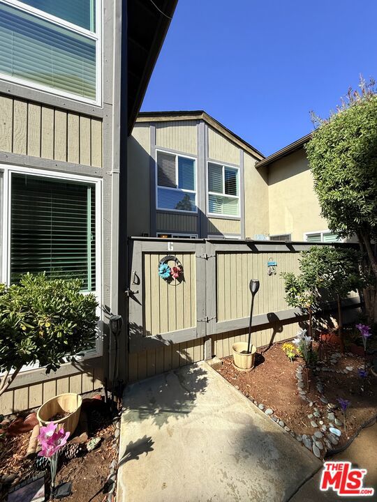 Delightful two-story townhome in the well-maintained gated community of Mariners Park Village. This home features two bedrooms and one full bathroom upstairs, plus a convenient half bathroom downstairs. The light-filled kitchen opens to a private patio through sliding doors, perfect for indoor-outdoor living. Two assigned covered parking spaces include generous storage. Community amenities include two pools, spa, playground, clubhouse, and BBQ areas. Whether you're a first-time home buyer searching for a place to call home or an investor looking for a solid opportunity, this home offers comfort, convenience, and value in a welcoming neighborhood. (Please note: Some photos have been virtually staged)