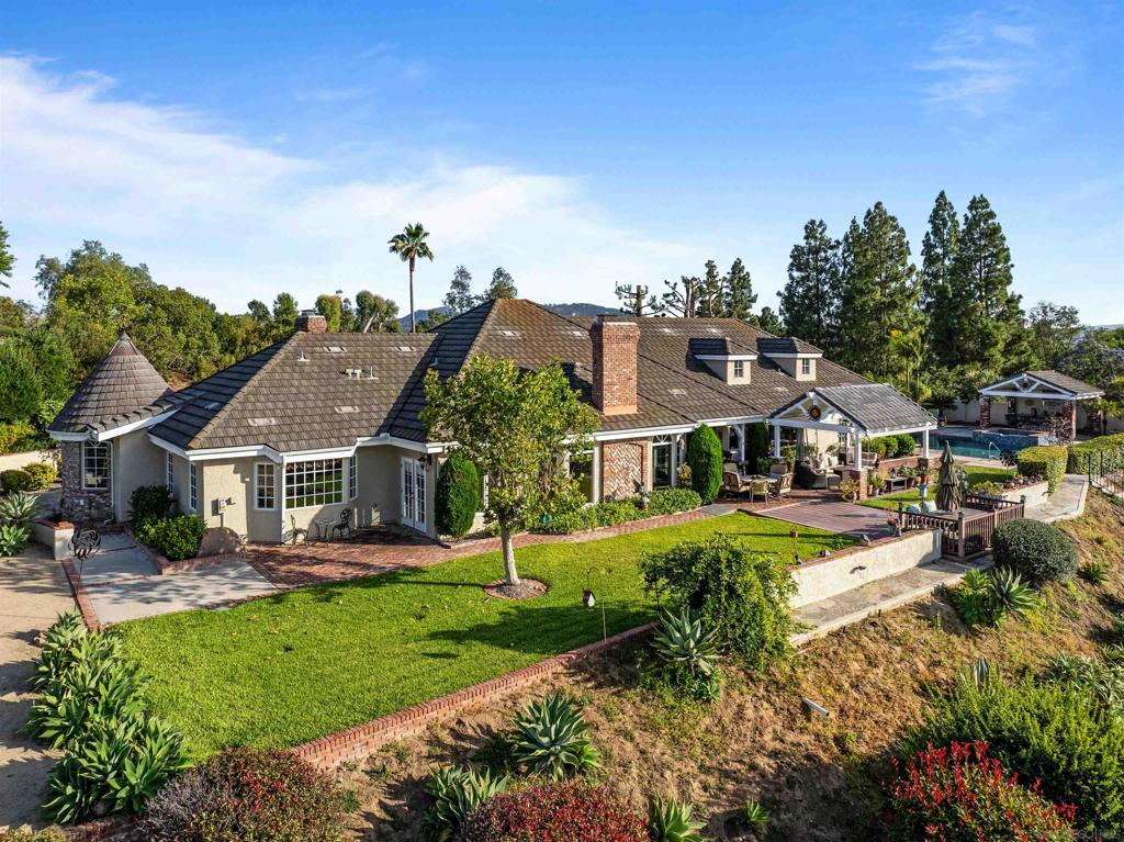 An expansive retreat in the hills of North Poway. Entering through a private gate up to 4500 square foot of quality craftsmanship. The interior is full of high-end finishes blending old-warm elegance with modern sophistications. Thoughtful design allows for effortless entertainment and intimate living with its single-level layout and large bonus area above the garage. The primary suite is large and private, occupying one end of the home while the secondary bedrooms sit on the other, meeting in the communal middle with a centrally placed kitchen. The grounds of the property are truly remarkable and give way to forever views. Over $750k in upgrades which include: Owned, ground-based solar system, Generac Natural Gas-Powered whole house generator, Whole-house surround sound system, Camera & security monitoring hard/software, gated RV parking, roof with warranty, windows, hard-wired Tesla wall charger, enclosed dog-run & dog washing station, pool remodel, and much more. Experience the allure of this property, a perfect blend of luxury and comfort, designed to cater to your lifestyle needs. This exquisite home stands ready to welcome its next discerning owner into a world of elegance and refined living.