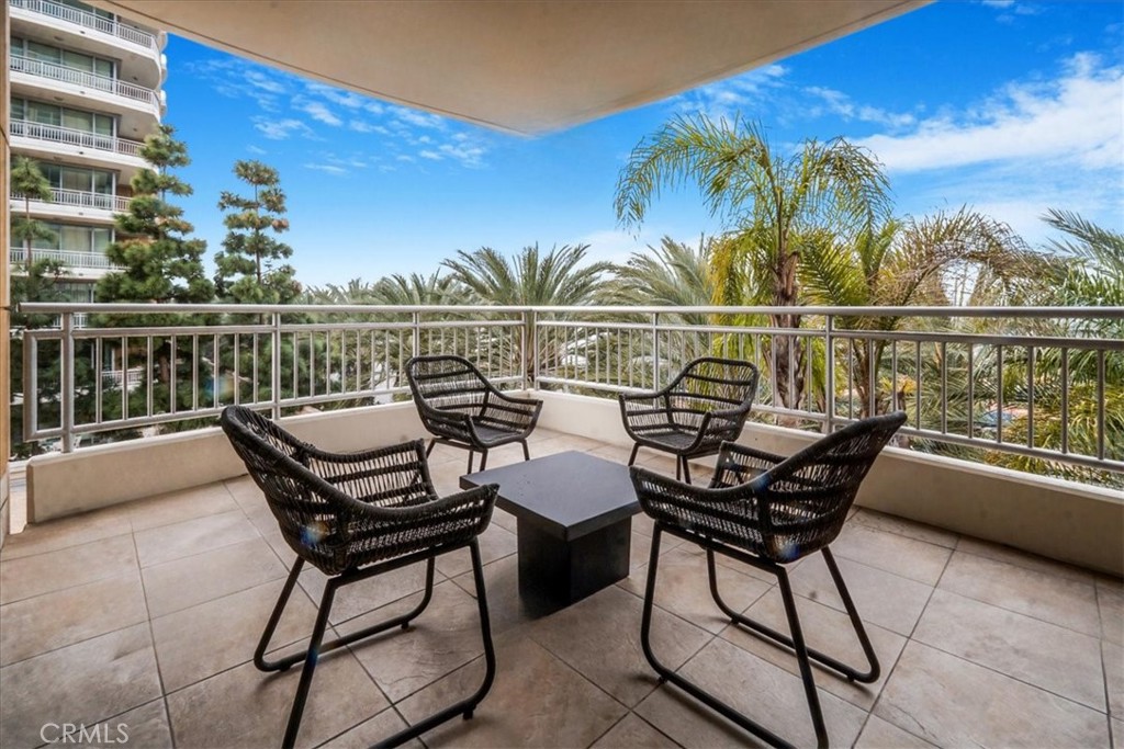 Experience luxury living every day at The Plaza, Irvine—where it feels like a permanent vacation. This pristine corner-unit home offers an expansive open floor plan and a large private deck with breathtaking city views from every room. Enter through a grand circular foyer with elegant stone flooring, leading to rich hardwood floors that extend into the den and great room. The floor-to-ceiling windows fill the space with natural light and stunning views, making this great room an entertainer's dream. The gourmet kitchen is equipped with top-tier Viking appliances, sleek granite countertops, and exquisite Italian cabinetry. The spacious primary suite boasts a lavish bathroom featuring travertine and granite finishes, with a separate tub and shower. Equally impressive, the second suite includes a generously sized bedroom and a beautifully designed en-suite bathroom. A versatile den off the foyer can serve as an office, game room, or formal living space. Additional conveniences include a full-sized laundry closet with washer and dryer. The Plaza offers unmatched resort-style amenities, including a rooftop pool and jacuzzi, state-of-the-art fitness center, private wine lockers, a recreation room, poolside BBQ area, and 24-hour concierge services. For frequent travelers, the building’s controlled access and close proximity to Newport Beach, top dining, shopping, major freeways, and John Wayne Airport make it the perfect location