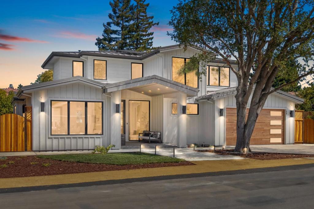 All-New, All-Electric Home Minutes from The Village. This new home offers thoughtfully designed luxury with every modern convenience. Completed with exceptional attention to detail, the entire property showcases designer selections and a flexible floor plan ideal for a variety of lifestyle needs. The home features expansive open living areas with soaring ceilings, and dramatic sliding glass doors that open to covered and open-air terraces. The kitchen is a true centerpiece with striking quartzite countertops, custom cabinetry, and a full suite of Miele appliances, including induction cooktop, 2 ovens, built-in coffee maker, dishwasher, and refrigerator. Upstairs, the luxurious primary suite features a cathedral ceiling, skylit walk-in closet, and spa-inspired bath. A spacious attached main-level ADU, with 2 bedrooms & 2 baths, has both private & interior access. Outside, the professionally landscaped grounds offer a built-in barbecue center, vast lawn, & multiple areas for entertaining. 3,743 SF home + ~900 SF of covered porches totaling 4,643 SF. 2-car garage with EV charging, 10kW solar system with 25 panels, metal roof; central vacuum; 3 HVAC units, 6 outdoor cameras with NVR; burglar alarm, app-operated Lutron switches, & wireless access points are preset on a dedicated iPad.