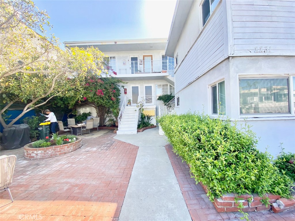 Wake up to the sound of waves and the salty ocean breeze at this charming 1-bedroom, 1-bath apartment, perfectly situated just one house off The Strand in North Hermosa Beach. This is more than a home—it’s a front-row seat to the quintessential Southern California lifestyle. Nestled in a quiet, sun-kissed courtyard framed by lush greenery, this light-filled beach retreat offers a peaceful escape just steps from the sand and surf. Start your mornings with a walk to Martha’s for breakfast, swing by the Green Store for a beach snack, or enjoy a sunset dinner at The Bottle Inn—your new neighborhood favorites are just around the corner. Located between the Hermosa and Manhattan Beach piers, you’ll be right in the heart of a vibrant beach community, yet tucked into a serene pocket that feels worlds away. The unit includes tandem parking for two cars, shared coin-operated laundry, and windows that open to views of the garden courtyard. If you've been dreaming of a life lived by the tides, this is your chance to make it real. Come see what it's like to live one door from the Strand—schedule your showing today.