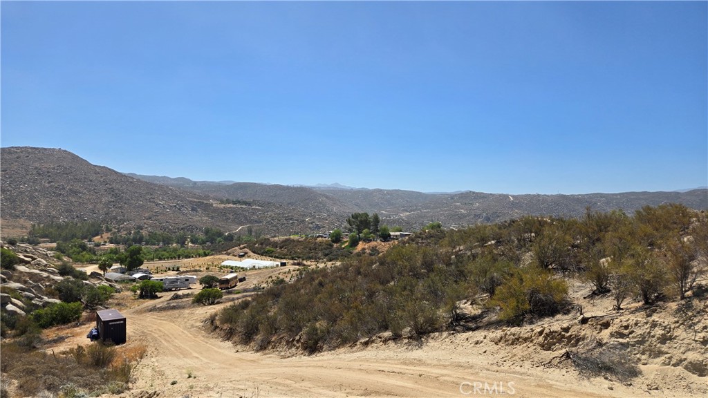 Just Under 10 Acres of Scenic Potential – Two Contiguous Parcels in the High Country of Anza
Two adjacent parcels—APNs 581-230-035 (4.61 acres) and 581-230-036 (5.10 acres)—are being sold together, offering nearly 10 acres of high-desert tranquility and panoramic beauty. With sweeping views of the surrounding rolling hills and the majestic Palomar Mountains, this is a rare opportunity to own a substantial piece of Southern California's rural charm.
If you're seeking a private, country setting to build your dream home, retreat, or homestead, look no further. Enjoy star-filled skies, clean mountain air, native chaparral vegetation, and seasonal wildflowers across a diverse and open landscape. Zoned W-2-M-5
Property Highlights:
Two Legal Parcels: Combined 9.71 acres, with flexibility for future use or resale.
Topography & Access: The parcel fronting Leo Road offers easier access and a broader, more usable terrain—ideal for building. The adjoining Schmidt Road parcel is more rugged and elevated, perfect for those prioritizing privacy, views, or natural preservation.
Utilities: Electric service is available at the property line, provided by a local cooperative known for offering some of the most affordable rates in California.
Zoning: Zoned W-2-M-5, which allows for a wide variety of land uses beyond standard residential, including agricultural, equestrian, and certain light commercial uses (buyer to verify with county).
Unimproved Land: A blank slate with no existing structures or utilities installed—ideal for custom development or conservation.
Corner Markers: Each parcel has one surveyed corner marked for reference (see attached supplements).
Lifestyle & Location:
Situated in an area rich with outdoor recreation opportunities including hiking, mountain biking, and horseback riding trails.
Low property taxes help make this a cost-effective long-term investment.
Just a short drive from Wilson Valley Road—a paved route for easy access to Hemet, Temecula, or Palm Desert.
The nearby town of Anza offers small-town amenities including restaurants, a bank, a medical clinic, and a casino. Local schools (K-12) maintain a favorable student-to-teacher ratio.
Whether you're looking to create a sustainable homestead, a weekend getaway, or an off-grid retreat, this unique offering gives you space, flexibility, and inspiration to bring your vision to life.