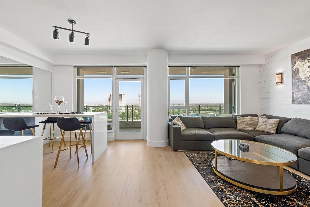 Modern Luxury - *Lease includes water, gas, trash and internet* This private 15th floor Plan C unit invites you to endless panoramic city and mountain views. Captivate yourself with breathtaking sunrises with one of the largest balconies sitting in one of Orange County's most prestigious high-rises. This unit has one of the most desirable layouts in the building, with two large bedrooms and a renovated home office - This smart, fully renovated condo has it all: A re-configured kitchen with added counter space, custom European cabinets with quartz counters, Alexa powered garbage disposal and lights, a five filter reverse osmosis system, a commercial 5 burner stove, marble backsplash, and custom LED lights underneath cabinet lights. The home is equipped with tongue and groove paneling throughout, custom wallpaper, and ceiling fans, a re-designed and re-configured master bathroom with dual waterfall showers, two nest thermostats, a ring doorbell. Custom-built dining table with the highest grade quartz for efficient use of space. Enjoy the highest grade scratch and waterproof laminate flooring, a large family room with built-ins for a 70' tv and a wall-mounted fireplace. This 24-hour guard gated community offers: a heated pool & spa, billiards room, gym, theater, lounge, outdoor BBQ stations. Minutes away from Fashion Island, South Coast Plaza, John Wayne, and the 405, 55, 73, and 5 freeways. Close to OC beaches. Luxury high-rise living at its finest
