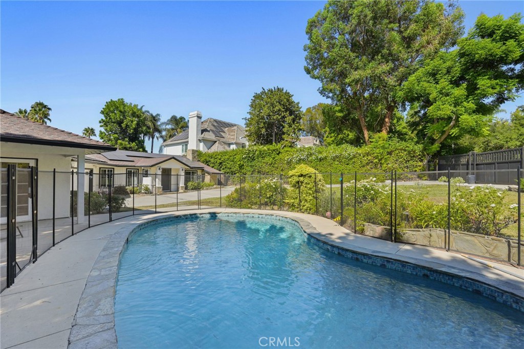 For Lease: Gated, Remodeled 4-Bedroom Home with Guest Suite, Pool & Solar – Prime Tarzana
Welcome to this beautifully updated one-story ranch-style home, located south of Wells Drive in one of Tarzana’s most desirable pockets. Set behind gates on an expansive 13,751 sq ft lot, this warm and inviting property offers the perfect blend of comfort, privacy, and convenience.
The main residence features four spacious bedrooms, including a luxurious primary suite with double-door entry, a dual-sink vanity, and a full bath. A fully permitted attached guest suite offers its own private entrance, high ceilings, recessed lighting, ceiling fans, a ¾ bathroom, kitchenette, and a separate HVAC system—making it ideal for extended family, a private office, or studio space.
The open-concept living and dining area is anchored by a dramatic floor-to-ceiling white marble fireplace, perfect for entertaining or cozy nights in. The remodeled chef’s kitchen boasts a large center island, stainless steel 6-burner stove, Sub-Zero wine fridge, refrigerator, microwave, and dishwasher, along with ample cabinetry and a custom glass tile backsplash. A nearby laundry room includes a washer and dryer, as well as walk-in pantry space.
Outside, enjoy a solar-heated pool, a newer raised entertainer’s deck, and a large grassy yard—ideal for kids, pets, or weekend gatherings. Full-home solar helps keep energy costs down year-round. The finished two-car garage provides direct access and can double as a creative workspace, gym, or playroom.
Located just minutes from Ventura Boulevard, this home is close to synagogues, kosher markets, top-rated schools, and local dining hotspots. Offered furnished or unfurnished, and available now for long-term lease.