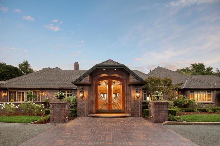 Elegant home built on 2.25 flat acres with breathtaking views of Campbell and San Jose. The classic one-story Endicott brick home is built for entertaining with formal living and dining areas. Lavish finishes such as marble tile and countertops, crystal chandeliers, hand-painted Venetian plaster walls, hand-carved Limestone fireplaces and Brazilian Walnut hardwood are found throughout the interior. A generous en suite master bedroom features his and her walk-in closets and a workout room. The park-like grounds include a well-appointed outdoor kitchen, swimming pool, spa, heated lounge areas, newly resurfaced tennis court, bocce court and gazebo with views of the valley. A four-car garage fortified to support an engine block winch rounds out the offering.  Live this grand lifestyle in an exclusive Saratoga neighborhood thats near to top-rated schools.