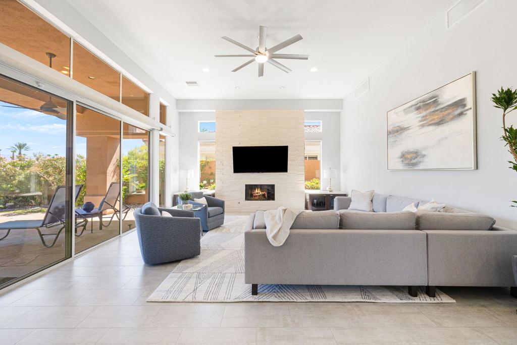 This Palo Verde 5 isn't just remodeled; it's been completely reimagined. From the moment you step through the gated courtyard, a tranquil water feature welcomes you like an old friend, setting the tone for the warm elegance that awaits inside. With 3,310 square feet of beautifully updated living space--including a detached casita, this 4 bedroom plus office (easily a 5th sleeping area), 4.5 bathroom home effortlessly blends modern design with comfort and charm. Perched on an elevated lot overlooking the 13th tee of the Grove Course, the views are nothing short of breathtaking. Each sunset paints the Chocolate Mountains in a new light, casting pink and orange hues that seems to dance just for you. Gather around the fire pit as the sky turns to twilight, this is where memories are made. The thoughtful upgrades extend beyond the interiors: pavers lead you through lush, newly landscaped grounds, while owned solar ensures energy efficiency. The HOA handles exterior maintenance including landscaping, roof care, and painting every 8 years so you can focus on enjoying the good life. With cable, Wi-Fi, and 24-hour roving security included, peace of mind comes built in. Located in Palm Desert's Indian Ridge Country Club--home to two Arnold Palmer designed championship golf courses and 1,068 residences across 640 acres, this home is more than a place to live. It's a lifestyle. This home comes completely furnished per Inventory List allowing you to bring just your toothbrush. Club membership available with no wait. Call us for a private showing today.