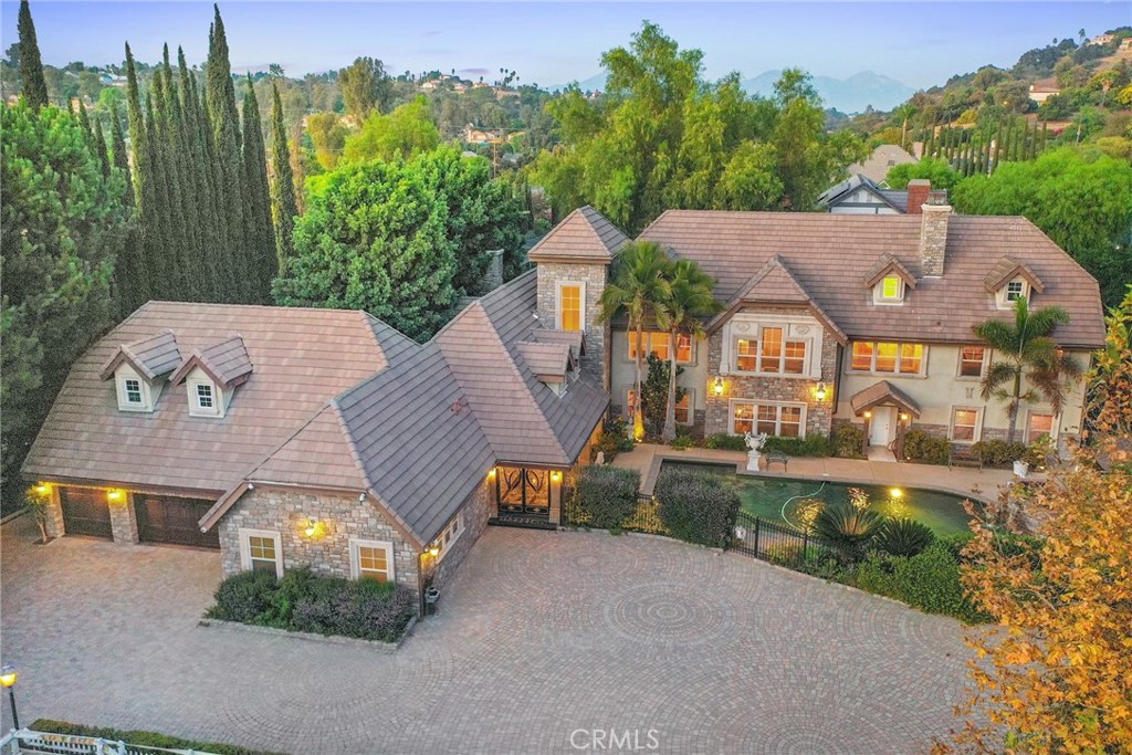 Designed by a Celebrity – A Masterpiece of Elegance and Distinction, set in the prestigious gated community of "The Country" in Diamond Bar, this remarkable German-style manor is a true architectural gem. Meticulously rebuilt between 2000 and 2002, and thoughtfully remodeled from 2020 to 2022, the home harmoniously blends timeless craftsmanship with modern luxuries. Encompassing approximately 7,660 square feet of exquisite living space, this 7 bedroom, 7.5 bath estate sits on a flat lot in the scenic foothills - one of the most coveted locations in the area. Elegant, inspiring, and distinctive design elements are showcased throughout, from the grand entry and sweeping staircase to the sophisticated finishes and intricate architectural details. High ceilings enhance the open and airy ambiance across the expansive main living areas. The home is ideal for both grand-scale entertaining and peaceful retreat, offering dual gourmet kitchens (Western and Chinese), a wet bar, sauna, gym space, meditation room, and a serene courtyard featuring a beautiful elephant fountain. Five of the seven bedrooms are en-suite and thoughtfully distributed across two levels, offering comfort and privacy for all. A flexible 928-square-foot loft space adds further versatility - ideal as a home office, media room, or creative studio. The 3-car garage ensures ample space for parking and storage. "The Country" community emphasizes privacy, luxury, and security, with 24-hour guarded access, regular security patrols, and resort-style amenities including hiking and equestrian trails, a heated pool, tennis courts, and a clubhouse. This is more than a home - it's a rare opportunity to live in a work of art, thoughtfully crafted and infused with elegance at every turn.