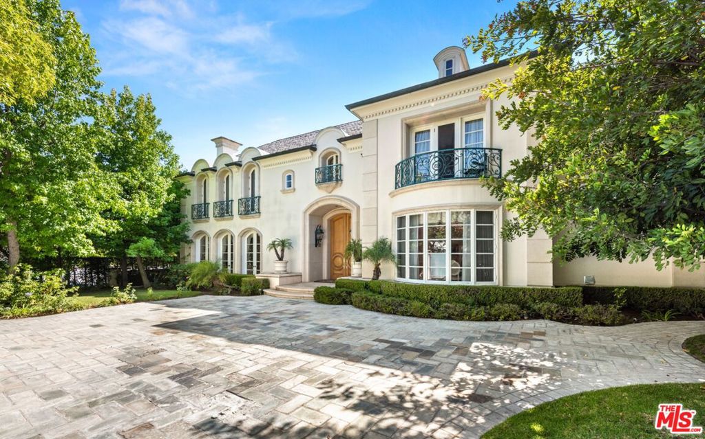 A luxurious Mediterranean-style villa set on almost half an acre in one of the most sought-after areas of Beverly Hills. Just beyond the gated drive you enter the home to a stunning foyer with grand staircase. The main level offers a beautiful formal living room, formal & informal dining rooms, library, and spacious kitchen. The primary suite on the second level features dual bathrooms, a large walk-in closet, living area, and private balcony. This home has 8 additional bedrooms to provide plenty of space for family and guests. Additional amenities include a media room with built-in bar and subterranean parking for eight cars. The backyard has a swimming pool, spa, and patio and is surrounded by lush greenery for privacy. This is a gorgeous home in The Flats of Beverly Hills with easy access to the best shopping and restaurants 90210 has to offer.