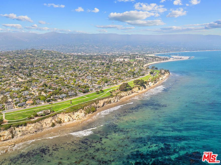 Oceanfront sanctuary where every day feels like a dream vacation. Elevated, private, and fabulously quiet, this soft contemporary retreat was designed by renowned architect Don Pedersen and built by esteemed builders Giffin & Crane.  This move-in ready 4 bedroom / 3 bath residence offers front-row, panoramic views of the sparkling Pacific Ocean and breathtaking sunsets. Step inside and feel instantly inspired this light-filled home welcomes you with a warm, uplifting atmosphere, thanks to soaring beamed ceilings, an open-concept design, and an extraordinary abundance of natural light pouring in through skylights and expansive glass doors. Intelligently elevated architecture allows you to enjoy sweeping ocean vistas from the private, spacious living areas that overlook lush green space and endless blue water beyond. The European-inspired kitchen features stone countertops, high-end appliances, and seamless flow into the dramatic living and dining areas perfect for entertaining or simply soaking in the serenity of coastal living. Just outside, glass doors lead to two private sunlit terraces, ideally situated for watching dolphins and sailboats drift by, or pelicans gliding across the horizon. The ideal primary suite is a true retreat, complete with panoramic ocean views, a cozy fireplace, a spa-like bathroom with dual vanities, two generous walk-in closets, and a private covered terrace with skylight perfect for enjoying a quiet morning coffee while taking in the rhythmic sounds of the sea. Flexible interior space includes a media room, studio, home office, or potential kitchenette setup, offering even more opportunities to tailor the home to your lifestyle. Outside, a garden oasis awaits a private, beautifully landscaped yard with a BBQ area, mature fruit trees, vibrant exotic succulents, and a private deck. There's even potential to add a lawn or lap pool, enhancing both your lifestyle and long-term value. Additional highlights include soft bamboo wood flooring throughout, dual-pane windows, air conditioning, a separate garden entrance, beach gate access, a hot outdoor shower, two-car garage with storage, and EV charger. Perfectly situated along Shoreline Park, near Hope Ranch and just minutes to Montecito, this home offers direct access to one of Santa Barbara's most coveted beachside neighborhoods. Located in the celebrated Washington School District, it's ideal for families and beach lovers alike. Your world will be filled with daily ocean strolls, sunrises and sunsets, playful dolphin sightings, seasonal whale watching, and colorful boats passing by. Enjoy art shows, nearby restaurants, wineries, and live music in the Funk Zone. With close proximity to golf, shopping, the Santa Barbara Airport, and quick 101 access for easy trips to Los Angeles, this home combines beauty, ease, and unmatched coastal living. Play in the waves, stroll the beach, kayak, paddleboard, explore tidepools, visit the Yacht Club, or simply relax and soak in the sun this is where your happiest memories on the coast begin.