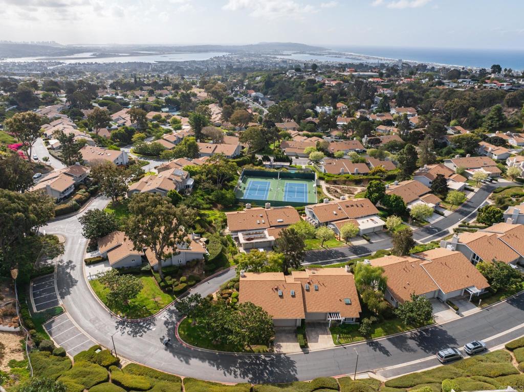 Set at the end of a private and serene cul-de-sac lies the rare opportunity to personalize one of the few fully detached units with idyllic views of San Diego and Mission Bay in the coveted 234-unit community of Mount La Jolla. This fully detached unit features a grand entry with high vaulted ceilings and floor-to-ceiling windows that drench the unit abundant natural light. Large windows and sliding glass doors line the entirety of the bottom floor taking full advantage of the beautiful views. Multiple patios wrap around the side and back for alfresco dining and sunset entertaining in Sunny San Diego. This unit has a large portion of outdoor space that could potentially be transformed into an even greater wrap-around patio complete with enough space for a beautiful private garden or yard, per HOA approval. The HOA has in fact allowed other units to absorb unused common areas for expansive outdoor space. The expansive primary suite offers a wall of glass and a private balcony to enjoy the gorgeous views from an even better vantage point. Finally, the property boasts a three-car attached garage complete with a wall of storage cabinets and room for even more storage while storing your vehicles. The community offers resort-style amenities including 4 pools (2 of which are heated year-round), 4 USTA tennis courts with lights, a fitness center with a stretching room, a spa and steam-saunas, a clubhouse with a fully equipped kitchen ready for larger parties and events, an inviting meeting room complete with a fireplace, a putting green, and walking trails lined with gorgeous lush landscaping throughout. All of this set atop a mountain just minutes from top-rated schools, beaches, dining and shopping in the Jewel of San Diego, La Jolla. This is a truly rare opportunity to enjoy coastal living at its finest!