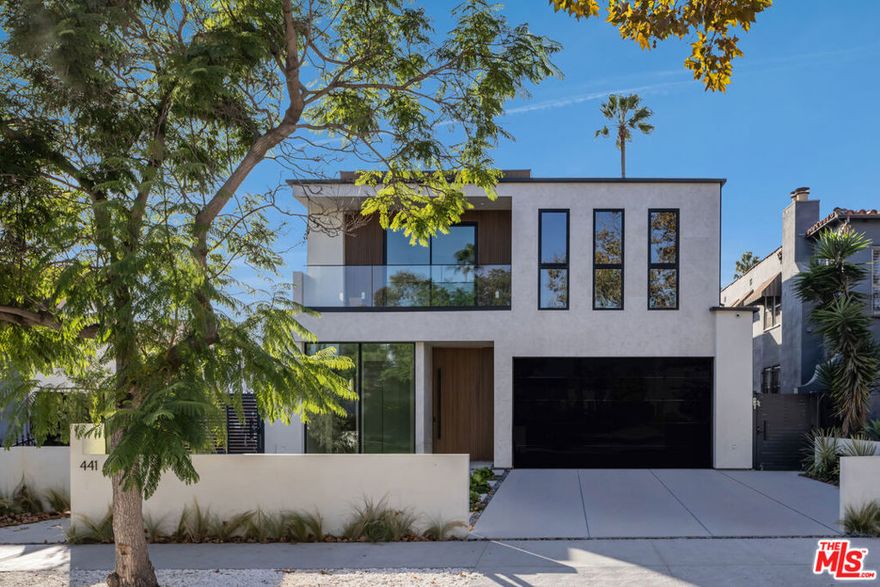 Step inside this newly built modern masterpiece where every element has been carefully composed to balance elegance, warmth, and architectural precision in the heart of Beverly Grove. This newly built home with a detached ADU showcases Italian craftsmanship, seamless flow and high-end finishes. A glass entry reveals open, luminous interiors framed by custom stonework and an abundance of natural light. The open-concept layout connects the formal dining area and living space through clean architectural lines and a sculptural floating staircase framed in glass. The custom Italian kitchen is appointed with bespoke cabinetry, professional-grade appliances, and a grand waterfall island that anchors the space with quiet elegance. Retractable glass doors erase the boundary between indoors and out, leading to a private entertainer's yard with a zero-edge pool, integrated spa, and lush landscaping. Upstairs, the primary suite embodies serenity with a private terrace, boutique-style dressing room finished in Italian millwork, and a spa-level bath featuring a steam shower and soaking tub. Each ensuite bedroom is individually detailed with custom vanities and designer finishes. The detached ADU offers versatility for guests, a home office, or a creative studio. Smart-home technology, curated stone and wood flooring, and meticulous detailing complete this modern sanctuary. Just moments from Melrose Place, The Grove, and Beverly Boulevard's dining and boutiques, this home represents the balance of sophistication, privacy, and modern design.