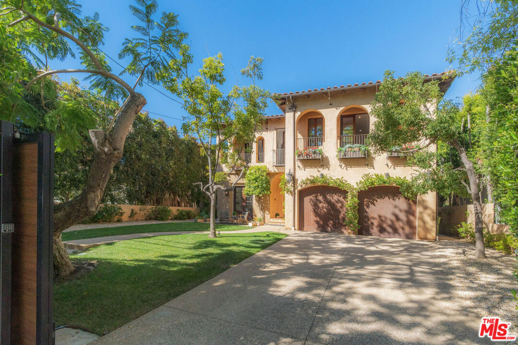 Modern Traditional interiors bring current style trends to a handsome European/ Mediterranean exterior architectural and offering streaming6 sunlight through endless french doors, windows spacious settings. The dramatic staircase rises from the Entry Hall to a tower with beamed ceilings and numerous clerestory windows shining light into the main entertaining areas. Exceptional Brentwood value. Renovated interiors reveal very high ceilings and vaulted spaces, all within a secure gated compound setting of beautiful mature trees and virtual privacy. Located near the heart of Brentwood Village and easily walkable to best restaurants, San Vicente markets & stores, this home offers convenience and the feeling of a refuge from the city at the same time. Excellent open floorplan leads from the Entry Foyer past an Office/Den setting into a grand central 2 story stairway that beams sunlight from clerestory windows into the center of the home that radiates into all the rooms. A large Sitting Room features a fireplace & hearth focal point and is adjacent to a very large Dining Rm seating for 14 guests. The eat-in white stone tile Kitchen is perfectly set for a serious cook, with abundant counter/ prep space, center island, endless cabinets & storage, a work desk and a walk in Pantry, overlooking the large backyard--which provides room for a Pool if desired. Kitchen opens to a huge casual living room with sets of French doors that open to the yard and a covered terrace for al fresco dining or summer barbecues. 4 bedroom suites up and 1 suite down that currently shows as a gym, but works nicely as a bedroom. All bedrooms enjoy high ceilings, large windows and gorgeous renovated baths. 3 bedrooms open to private covered terraces. The Primary Suite is a penthouse anywhere else enormous space, fireplace lounge, large covered terrace overlooking the backyard, 2 walk in closet dressing rooms and jaw-dropping white stone premium bath suite. Giant 2 car Garage plus 4 additional cars in gated motorcourt allow for 6 cars off street. The beauty of Brentwood living made easy.