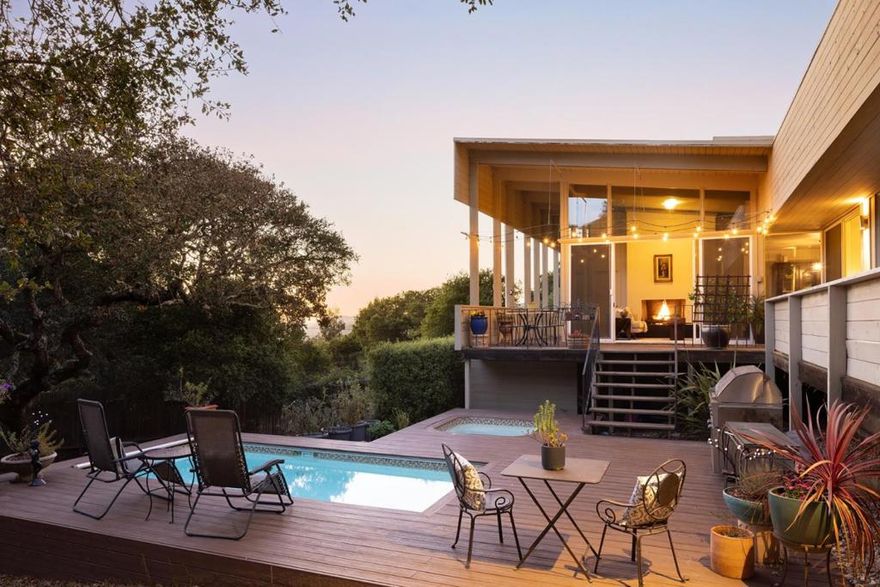 Nestled at the end of a quiet cul-de-sac, this beautiful mid-century modern home captures the essence of Carmel Valley living with walls of glass, high ceilings, and abundant natural light. Set on an oak-studded 1.1-acre lot, the 1,924 sq. ft. residence enjoys mountain vistas and seamless indoor-outdoor flow. The open-concept kitchen, living, and dining areas lead to an expansive deck overlooking a sparkling pool, relaxing hot tub, and BBQ patio, perfect for entertaining or unwinding. The main home features 3 bedrooms and 2 baths, while the attached guest suite offers an additional bedroom, bath, and kitchenette with its own entrance, ideal for guests or flexible multi-generational living. Additional highlights include a fenced backyard, new retaining wall near the driveway, electric car charger, and a two-car garage. Just minutes from the Village's shops and restaurants, this warm, modern home is the perfect year-round residence or serene vacation escape.