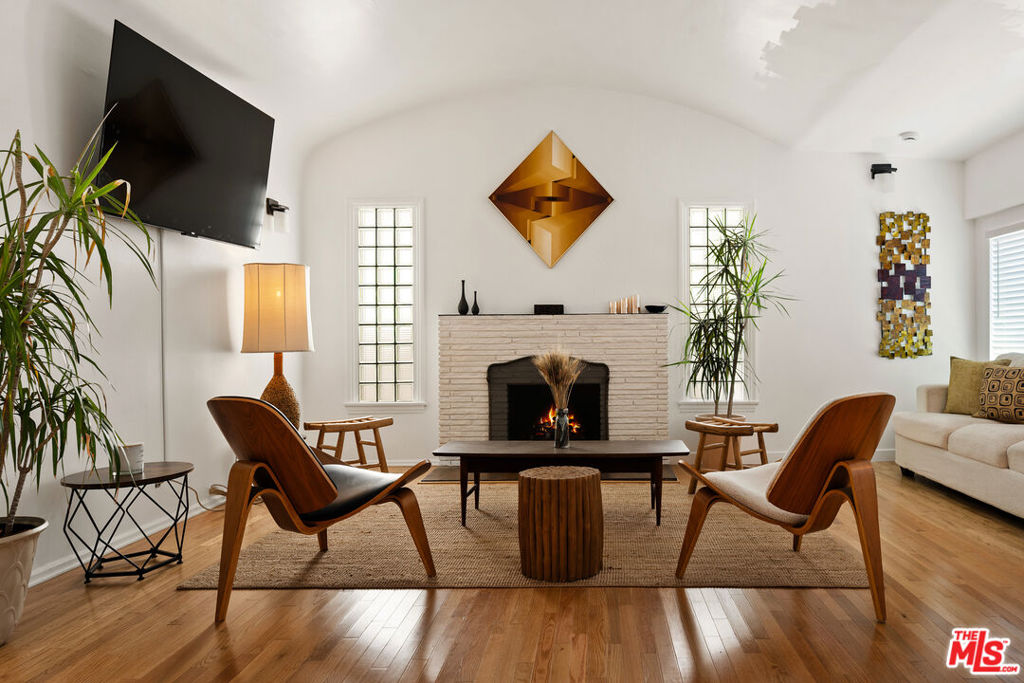 Charming Spanish-Style Bungalow in Prime Beverly Grove! Updated 2-bedroom, 3-bath low maintenance bungalow nestled in one of Los Angeles' most desirable neighborhoods. Located in the heart of Beverly Grove, this charming home blends classic 1920s details with modern upgrades for the ultimate in SoCal living. A private, gated front yard leads you into a sun-drenched interior featuring hardwood floors and arched doorways. The spacious living room is highlighted by a dramatic barreled ceiling and a decorative fireplace- ideal for entertaining or relaxing. The formal dining room flows seamlessly into the large galley kitchen with ample storage and countertop space. French doors lead to a serene, private backyard oasis, perfect for dining al fresco with friends! 1 car garage has been converted to a bonus room that can easily transform into a tranquil office or a creative studio. Laundry room with Washer/Dryer. Additional features include a detached garage with potential for an ADU conversion (buyer to verify), central HVAC, and updated systems throughout. Located just moments from The Grove, Melrose Avenue, and some of LA's best shopping, dining, entertainment, and all the best that Los Angeles has to offer ! ** Broker/agents do not guarantee the accuracy of square footage, lot size, or other information concerning the condition or features of property provided by the seller or obtained from public records.**