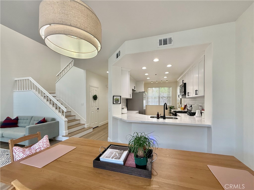 QUIET, BRIGHT, BEAUTIFULLY UPGRADED HOME in Prime Tustin Ranch Location!
Welcome to this spacious, stylish UPDATED townhome located in the highly desirable Arcada community—just a short walk to The Market Place in Tustin, offering endless options for dining, shopping, entertainment, and more. This home has been thoughtfully enhanced over the past two years with modern touches throughout, including all-new designer bathrooms featuring upgraded countertops, custom cabinetry, elegant fixtures, and chic finishes that give the home a fresh, elevated feel.
The KITCHEN has also been refreshed with a beautiful new backsplash, complementing the timeless white cabinets, stainless steel appliances, and sunny breakfast nook. Bright and cheerful with soaring ceilings and abundant natural light, this home feels welcoming from the moment you step inside.
Enjoy one of the most sought-after floorplan in the neighborhood, complete with newer wide-plank laminate floors, recessed lighting, and some newer dual-pane windows that flood the space with natural light. The home offers sample storage options too. The open-concept living and dining areas center around a cozy fireplace and offer direct access to the private backyard patio—an ideal setup for both relaxed evenings and vibrant gatherings.
A highly versatile MAIN-LEVEL BEDROOM and FULL BATH provide the perfect space for guests, in-laws, or a home office. Upstairs, the expansive primary suite offers vaulted ceilings, multiple dual mirrored closets with built in drawers, and a spa-inspired bathroom with dual vanities, soaking tub, step-in shower, smart fan, and adjustable lighting. Attention to every detail in the luxurious primary bath. A third bedroom, additional full bath, hallway linen storage, and a convenient upstairs laundry closet with full-size hookups complete the upper level.
The BACKYARD PATIO has been recently repaved and refreshed and backs to a peaceful greenbelt, creating a private outdoor oasis for BBQs or quiet mornings with coffee. The outdoor space is one of the largest in the community.
Perfectly located near community parks, scenic trails, top-rated schools, and with easy access to the 5 and 261 freeways, this home offers the ideal blend of comfort, style, and convenience. Whether you're entertaining friends or simply enjoying the peaceful surroundings, this turnkey home is move-in ready and sure to impress.
