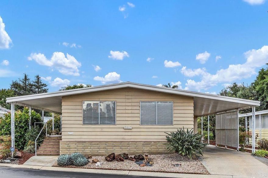 Welcome to El Camino Estates, a real Carlsbad gem. Introducing 4967 Cindy Ave., the only home in the community that directly faces the lovely community pool, offering a rare and relaxing view right from your doorstep.  Guests will also find plenty of parking right across the street. This meticulously maintained home features 1,488 square feet of comfortable living space with large rooms, an open layout, and plenty of natural light throughout. The interior boasts a generous, updated kitchen, with sleek cabinets, perfect for everyday living or entertaining. The primary bathroom has been tastefully updated, creating a clean, contemporary space to unwind. Every room in the home feels spacious and inviting, with fresh paint and new carpeting, creating a perfect pallet for your own design choices.  This home is truly move-in ready.  You will enjoy the backyard, which comes with fruit trees and is easy to maintain. Beyond its appealing living spaces, this home also includes extensive soil remediation work beneath the home.  You will enjoy the benefits of the extensive remediation work that included 1¼ tons of decomposed granite (DG) concrete, which provides stability and durability. To help neutralize any past soil concerns, lime and DG were carefully bucketed under the home, and ventilation ports were added to promote healthy air circulation and prevent moisture buildup. Additionally, the air handling system was modified to a fresh air intake system. Finally, the entire lot was recently (2023) re-rocked with 4 inches of new rock over new barrier cloth.    These upgrades not only add peace of mind, but they also enhance the long-term integrity of the property. Don’t miss this rare opportunity to own a spacious, upgraded home with an abundance of proactive maintenance, in a pristine 55+ community where you OWN THE LAND. This prime location, with gated entrance and separate RV parking, surrounded by million-dollar homes, could be yours soon.  Schedule your private tour today!