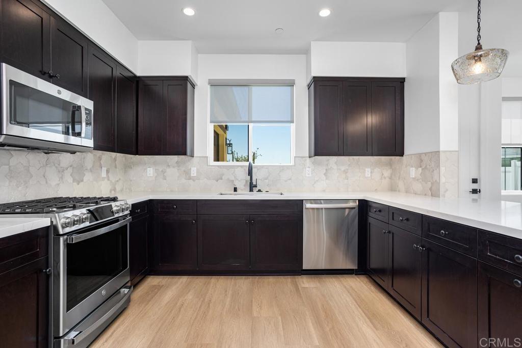 Welcome to Stonemark Estates. Brand New Construction- 2 bedrooms, 1 bath detached guest home, one car garage plus fenced backyard! EXCEPTIONAL EXTERIORS - Each ADU. home includes approx. 1200 sq. ft. with a private entrance, kitchen with quartz countertops, full-size fridge, gas washer/dryer, and a luxurious bathroom with a floor-to-ceiling tiled walk-in shower. Designer-inspired exterior lighting enhances the contemporary curb appeal. Spacious private patio. Durable concrete tile roofing. Low-maintenance landscaping with artificial turf. Large sliding glass deck doors for seamless indoor-outdoor living. LUXURIOUS INTERIORS - 10' foot volume ceilings and 8-foot insulated fiberglass doors throughout. Vinyl plank flooring in main living areas with plush carpet in bedrooms, closets. Recessed fire sprinklers for added safety. Elegant black contemporary door hardware and hinges. Designer roller shades for privacy in bedrooms and bathrooms. CHEF-CALIBER KITCHENS - Upgraded GE Series appliances. Quartz countertops with full tiled backsplash. Extra-large kitchen island with waterfall quartz countertops and built-in storage. Soft-close shaker cabinetry with black hardware and adjustable shelving. Designer pendant lighting. TECHNOLOGY & ENERGY EFFICIENCY - High-efficiency LED lighting throughout. Solar system. Tankless water heaters with direct vent. Prewired high-speed internet and data wiring for wall-mounted TVs in living rooms and primary bedrooms. Experience unparalleled luxury and thoughtful design in every detail at Stonemark Estates. Tenant pays all utilities. Owner pays common area maintenance. Pet Policy $100 per month Tenant pays all utilities. Owner pays common area maintenance. $35 Lease signing fee per adult. Tenant pays Zillow application fee.