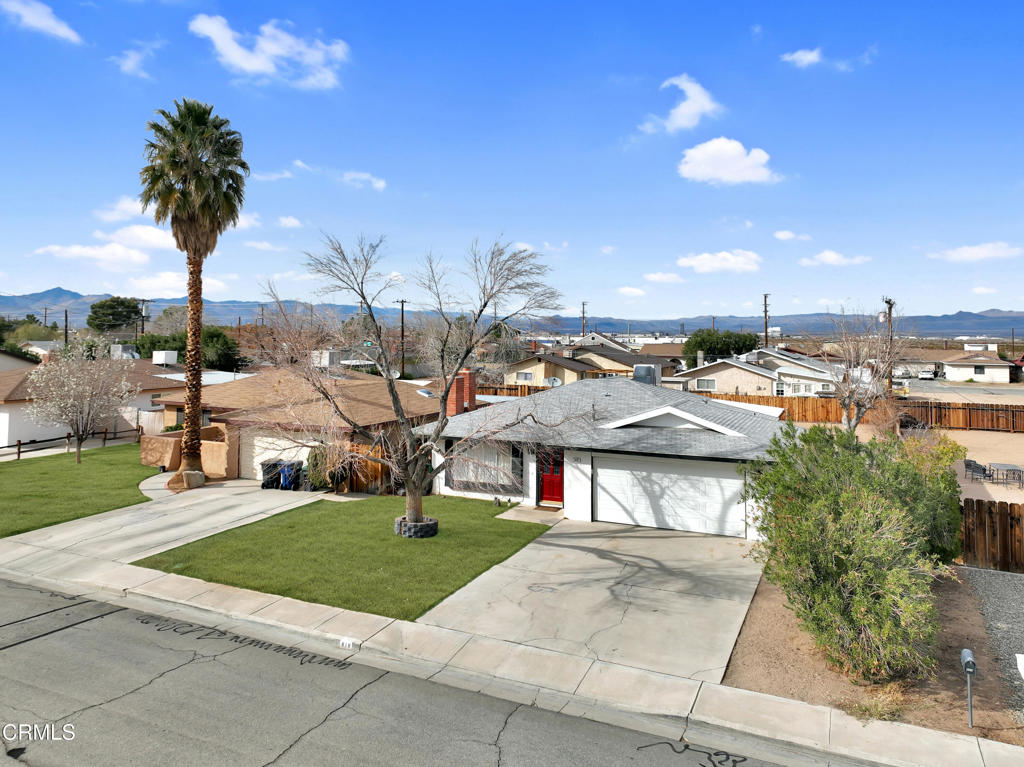 Welcome to this charming 3-bedroom, 2-bathroom home nestled in the heart of Ridgecrest! This inviting residence boasts a spacious front yard with lush green grass and a majestic palm tree, offering exceptional curb appeal. Step inside to discover a cozy living room featuring a beautiful brick fireplace, perfect for warming up on cool evenings. The kitchen is a chef's dream, equipped with modern stainless-steel appliances, ample wooden cabinetry, and a delightful view of the backyard through a large window. The open dining area seamlessly connects to the kitchen, providing an ideal space for entertaining guests.The generously sized bedrooms offer plush carpeting and ceiling fans for comfort, with the primary bedroom featuring a walk-in closet. The expansive backyard presents a blank canvas for your imagination, with a vast open space, a storage shed, and room for gardening, play, or outdoor gatherings. The home's fresh paint and well-maintained interior create a bright and welcoming atmosphere throughout.With its combination of comfort, charm, and potential, this property is a must-see for anyone looking to settle in a friendly neighborhood with mountain views and easy access to local amenities. Don't miss the opportunity to make this house your new home!