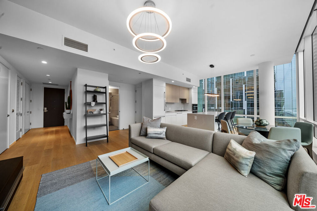Experience the perfect blend of sophistication and modern luxury at Metropolis II, one of Downtown LA's premier high-rise communities. This stylish 2-bedroom, 2-bath residence showcases floor-to-ceiling windows, wide-plank wood flooring, and breathtaking panoramic views of the iconic city skyline. Designed for both comfort and entertaining, the open-concept layout flows effortlessly from the living and dining areas to the chef-inspired kitchen. Outfitted with top-of-the-line Miele appliances, designer finishes, and a generous center island with a built-in beverage chiller, the kitchen is the ideal space to cook, host, and createall while enjoying the dazzling city lights. Adding to its exclusivity, this home is located on one of only three levels at Metropolis II that boast exceptionally high ceilings, enhancing the sense of space and light. The sun-drenched primary suite offers a tranquil retreat with a spa-like bath and expansive closet, while the second bedroom provides flexibility for guests, a home office, or creative studio.As a resident of Metropolis, you'll enjoy an impressive collection of amenities including a resort-style pool, state-of-the-art fitness center, business center, private screening room, 24-hour concierge, and a dedicated dog park. Perfectly situated in the heart of DTLA, you're moments from world-class dining, shopping, cultural landmarks, and even a Starbucks conveniently located at the neighboring Indigo Hotel. Don't miss your chance to live in one of Los Angeles' most sought-after addresses, where every day feels like a luxury escape.