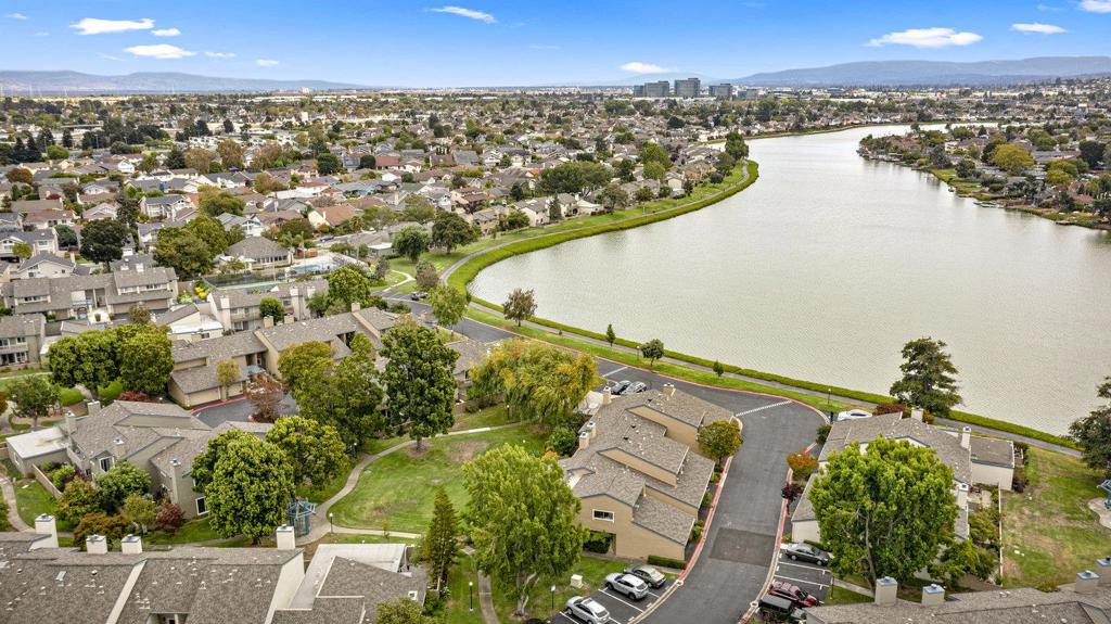 Tucked within one of Foster Citys most desirable neighborhoods and just steps from the tranquil lagoon, this beautifully appointed townhome offers the space and feel of a single-family residence with refined details throughout. The main level features light wood flooring, classic crown molding, and a welcoming family room with recessed lighting and a raised-hearth fireplace. A sliding door opens to a lush, private backyard - opening to a greenbelt-like setting just beyond the gate, perfect for outdoor entertaining, stargazing, or your morning coffee. The dining area flows effortlessly into the kitchen, which boasts a clean, neutral palette and functional layout ideal for gatherings both large and small. A well-placed half bath adds convenience on the main floor. Upstairs, the light wood floors continue into three spacious bedrooms. The updated hall bath features double sinks and modern finishes. The primary suite is a serene escape with its own en-suite bath and a sliding door to the balcony, overlooking the greenery beyond. Additional highlights include an attached two-car garage with custom in-garage storage. Enjoy the perfect balance of comfort, charm, and an unbeatable location near water trails, parks, and top-rated schools in the heart of Foster City.