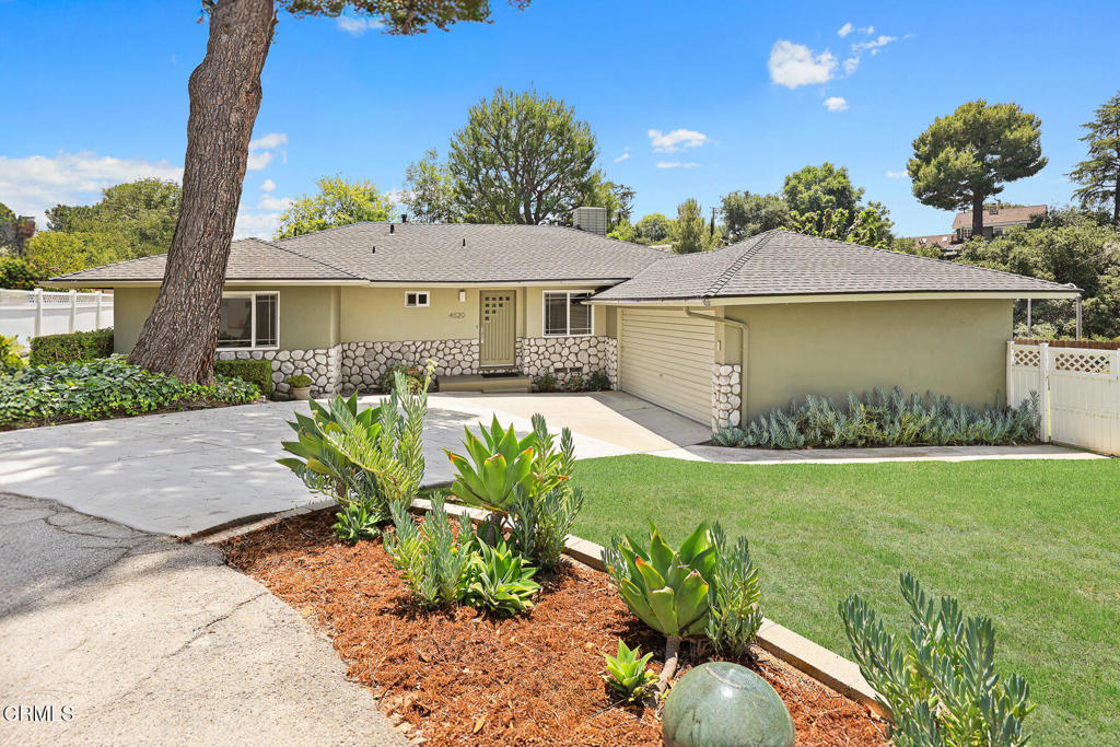 Tucked away at the end of a private driveway, this beautifully upgraded and meticulously maintained 3-Bedroom, 2-Bathroom home sits on a 9,883 sq ft lot. Step inside to a warm and inviting floor plan designed for comfortable everyday living. The spacious Living Room features a refined stone-faced gas fireplace, expansive windows, and wood flooring--creating an ideal space for relaxing or entertaining. At the heart of the home, the updated Kitchen showcases quartz countertops, shaker-style cabinetry, stainless steel appliances, and a center island with convenient bar seating. Adjacent to the kitchen, the light-filled Dining Area opens to the lush backyard through sliding glass doors. A wood-floored hallway with additional storage leads to the private bedroom wing. Two secondary Bedrooms are bright and airy, each offering ample closet space. The recently remodeled hallway Bathroom includes a shower-over-tub combo, stylish tile flooring, and modern fixtures. The Primary Suite enjoys abundant natural light and an en-suite bathroom for added privacy. The private Backyard is ideal for year-round entertaining. Enjoy the large covered patio, mature landscaping, and plenty of space to relax or play in every season. Additional features include an attached two-car garage, newer central air and heat, upgraded electrical panel, newer roof, earthquake retrofitting, and copper plumbing. All of this is located in the highly sought-after La Canada Flintridge, within the award-winning La Canada Unified School District. Just minutes from shops, restaurants, the YMCA, scenic hiking and biking trails, and with easy access to DTLA. Welcome Home!
