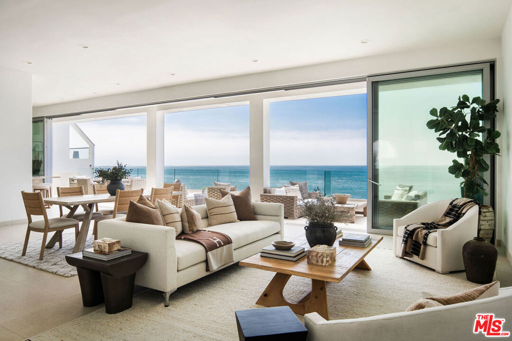 Spectacular Malibu Beachfront Retreat with 61 Feet of Ocean Frontage on private street with deepest sandy beach! Experience luxury coastal living in this expansive 3,500 sq ft Malibu beach home, perfectly situated on a rare private street with no through traffic and generous off-street parking for all guests. Boasting 61 feet of pristine beach frontage, this architectural gem offers panoramic ocean views from every room. The entry level welcomes you with soaring ceilings and dramatic walls of custom glass sliders that blur the line between indoors and out. A spacious open-concept living and dining area flows seamlessly to a wraparound oceanfront deck, perfect for entertaining or relaxing to the sound of the waves. The chef's kitchen is a showstopper, outfitted with premium appliances and stunning Taj Mahal natural stone countertops and island. The entire top floor is dedicated to a luxurious primary retreat featuring high ceilings, a cozy fireplace, new Fleetwood sliders and windows, and sweeping views of the Pacific. The spa-inspired primary bath includes a steam shower, soaking tub, and a generous walk-in closet. Step outside to your private rooftop veranda nearly 800 sq ft of outdoor living space with an ocean-view spa and lounge area, rarely found in Malibu. The lower level hosts three spacious guest suites, each with en suite bathrooms and ocean views. A private deck offers yet another peaceful spot to take in the beauty of the coastline. Follow the newly rebuilt staircase down to your own private sandy beach terrace complete with an outdoor shower and oversized storage area for surfboards and beach gear. This exceptional property combines modern luxury, privacy, and timeless oceanfront appeal a rare opportunity to own a true Malibu escape.
