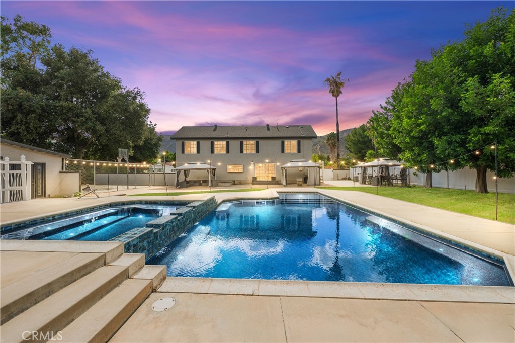 Stunning 4-Bed Estate on Over Half an Acre – $250K in Upgrades, Pool, Spa & Casita! Experience modern elegance in this beautifully renovated two-story 4-bed, 3-bath estate offering 3,175 sq. ft. of living space nestled on an impressive lot spanning over half an acre. Nearly every inch has been updated, featuring new wide-plank flooring, fresh interior and exterior paint, quartz kitchen counters, a custom coffee bar, repainted staircase, and new cabinets upstairs. The property features an expansive front yard and an extended, fully fenced driveway that provides exceptional privacy and abundant parking. The primary suite offers dual walk-in closets, a fireplace, and a spa-inspired bath with soaking tub and oversized shower. The detached guest studio (casita) with a full bath has been completely upgraded with a new mini-split HVAC, tankless water heater, and electrical panel, perfect for guests or multi-gen living. Enjoy outdoor resort-style living with a newly re-plastered and repainted saltwater pool and spa, two cabanas, sport court and beautiful new vinyl fencing surrounding the entire property. Additional highlights include new toilets, a newer main water heater, a whole-home water softener system, upgraded garage with new plaster, paint, and cabinetry, RV parking, detached storage, and paid solar. No HOA, low taxes, and a prime location near the lake, schools, and shopping make this a rare find in luxury living!