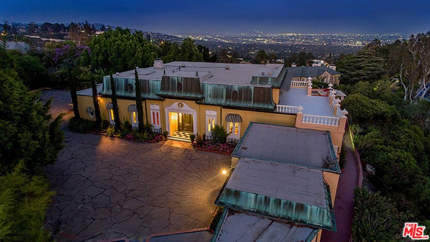 Once-in-a-lifetime opportunity to own a piece of Hollywood history. Located in the prestigious East Gate area of lower Bel Air, this spectacular property was once the home of a famous Hollywood legend. Situated on an over 1 acre gated & private lot w/fantastic jetliner views from Downtown to the ocean, this property offers an incredible opportunity to remodel the existing apx. 8,878 sq.ft. Regency-style home or build Los Angeles's newest iconic estate. Plans available from Harrison Design for an apx. 24,020 sq.ft. 2-story estate including 4,100 sq.ft. of garage space & below-grade lower level. The current home offers spacious & elegant rooms w/beautiful original details & high ceilings. Gracious foyer, formal living rm, formal dining rm, sitting rm, office, breakfast rm, & chef's kitchen. Spacious master suite. Huge upper level bonus rm & hammam opens to the Monte Carlo style roof-top terrace offering spectacular views & space for entertaining. Expansive patio space & pool.