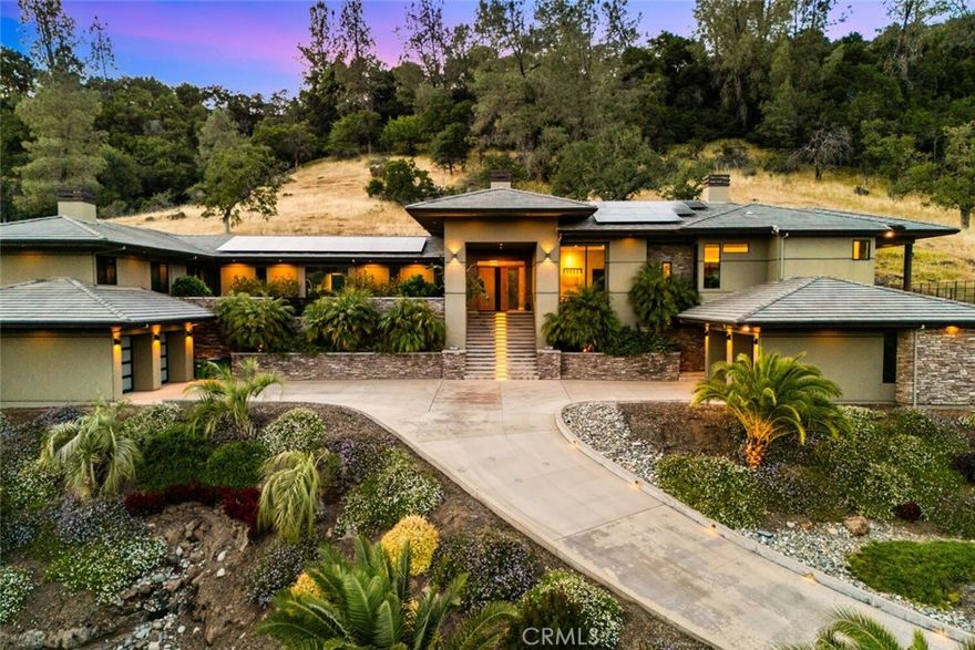 Modern luxury, intentional design, and unmatched views—welcome to 3386 Canyon Oaks Terrace, one of the most spectacular homes in Chico and Canyon Oaks Country Club. Step through the striking pivot front door and into a thoughtfully designed interior featuring walnut kitchen cabinetry, high-end stainless appliances, and Sierra Pacific wood-clad windows that flood the home with natural light. The centerpiece of the living space is a sleek, cold-rolled steel fireplace facade with a precast white concrete hearth—modern yet warm. An entertainer’s dream, the home boasts an outdoor kitchen just steps from the pool, a Weiland lift-and-slide door for seamless indoor-outdoor flow, and a front-facing electronic ignition fire pit where you can take in show-stopping sunsets over the course. Inside, let the guests pamper themselves in the spa-like hall bathroom with a dramatic backlit onyx vanity with access into the guest room or hallway. The private primary suite is its own retreat, complete with a two-way fireplace and a flexible second room perfect for a home office, gym, or library. Custom built with purpose and precision, this residence was thoughtfully designed by the sellers to raise their family of five. A completely separate wing of the home offers privacy and functionality, featuring three bedrooms, two bathrooms, and a shared common room—ideal for kids, guests, or multigenerational living. Additional highlights include an elevator with basement storage and rotating closet carousel, four-car garage with electric vehicle charger, owned solar (with just a $5,000 annual true-up), and solar pool heating. Adjacent to the home, the expansive open space is permanently protected and will never be built on—ensuring unobstructed, panoramic views and lasting privacy with no direct neighbors.

This is more than a home—it’s a legacy property designed for living, entertaining, and enjoying the best of Canyon Oaks Country Club.