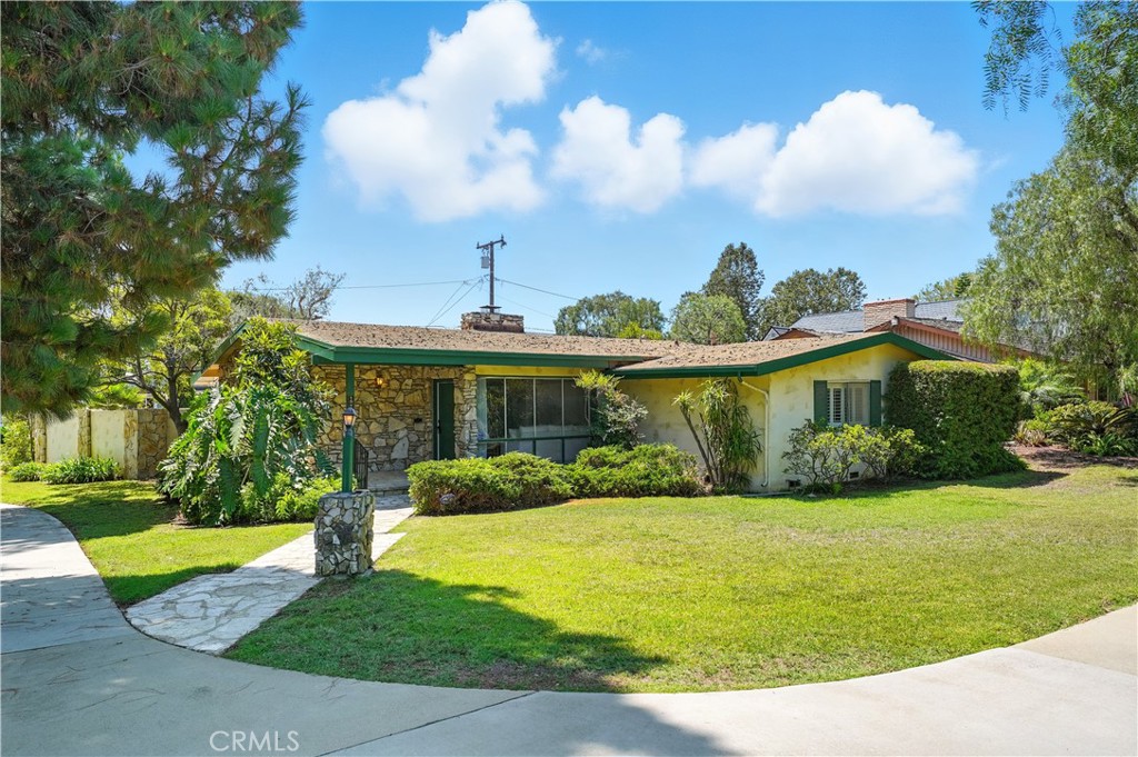 Welcome to this one-story ranch in sought after Park Estates offering 3 bedrooms, 3 bathrooms, and 2,131 square feet of living space complete with a 3-car garage on an 8,990-square-foot corner lot. Mid-century details greet you at the door including vaulted ceilings with wood-accented beams and built-in bookcases. A striking double-sided stone fireplace and dramatic floor-to-ceiling windows fill the open-concept living and dining areas with natural light. The remodeled kitchen features a well-designed layout, a skylight, and space for a coffee bar. A nearby three-quarter bathroom with shower and indoor laundry hookups add convenience. The double-sided fireplace connects the living area to an inviting family room featuring a wall of sliding glass doors that lead to the backyard. For added privacy, a pocket door separates the common areas from the bedrooms. The primary suite offers dual sliding-door closets, a charming “pretty in pink” ensuite bath, and direct access to the patio. Two large bedrooms down the hall share a full bathroom with a period-style tub, dual-sink vanity, and greenhouse window, while showcasing vaulted, beamed ceilings and built-in closets. Outdoors, enjoy a backyard with mature trees, a raised patio seating area, and the detached 3-car garage with an additional laundry hookup. With its thoughtful floor plan, architectural charm, and abundant natural light, this home is a true gem—don’t miss your chance to bring your vision to life.