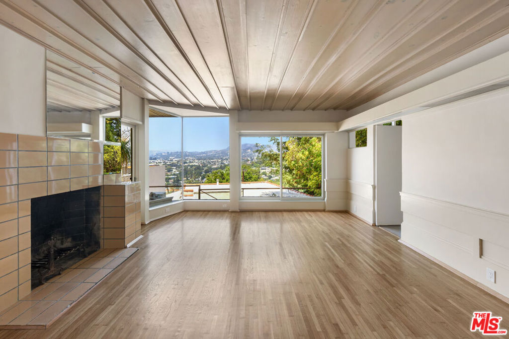 Available for an 18+ month lease, live in one of the Sachs Apartments, the modernist jewel by renowned architect Rudolf Schindler. Located in prime Silver Lake, this airy one-bedroom unit features Schindler's signature woodwork detailing and oversized windows framing lovely views of the Griffith Park Observatory and Hollywood Sign. The apartment has features that include stylish built-ins, a dining nook, beautiful wood flooring and stainless appliances by Fisher & Paykel. Amenities include a private garage for one vehicle, balcony, air conditioning, a dishwasher and an in-unit washer and dryer. The intimate 16-unit complex places you a few short blocks from the Silver Lake Reservoir and Sunset Junction, providing nearby options for coffee, dining, nightlife, and the twice-weekly Silver Lake Farmer's Market. Schindler's groundbreaking style is often imitated but has never been surpassed; in this modernist time capsule you can reside within architectural history.