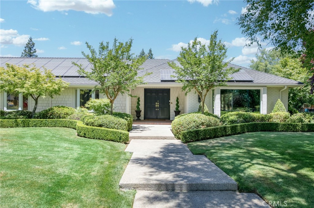 This stunning, turnkey home off Van Ness Extension offers everything you desire! Enjoy single-story living with 4 bedrooms, a sparkling pool, and a spacious 3-car garage. The 2020-installed solar system adds to its appeal, all situated on a generous corner lot. Mature trees and a charming exterior welcome you to this Northwest Fresno gem. Inside, you'll find beautiful hardwood floors, a pleasant color palette, and vaulted ceilings in the main living areas. With both formal and casual living/dining spaces, plus an expansive primary suite featuring a sitting area, there's room for everyone. The backyard is an entertainer's dream, boasting a large pool, covered patio, and a grassy area. Some of the many updates include newer hot water heaters, interior and exterior paint, updated plumbing, fixtures and lighting. All this plus ample parking and a large garage with epoxy flooring. Go see it today! Bathroom count differs from tax records.