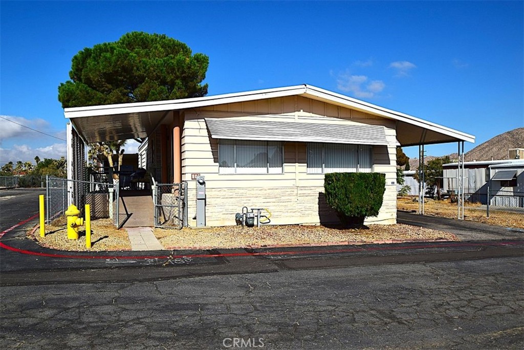 Retire in comfort and style in this spacious double-wide mobile home, located in a tranquil senior community in beautiful Yucca Valley. This charming home offers an inviting open floor plan perfect for easy living and entertaining, with plenty of natural light streaming through large windows.
With two bedrooms and two baths, this home provides both comfort and convenience. The bright, spacious kitchen has ample storage, and the private covered patio is ideal for relaxing desert evenings. The low-maintenance yard offers space for gardening or simply unwinding. Community amenities include a clubhouse, pool, and planned activities to keep you engaged and connected.
Live just minutes from scenic nature trails, local shopping, and the stunning vistas of Joshua Tree National Park. Here, in the heart of Yucca Valley, you can enjoy the serene desert landscape while staying connected to a friendly, vibrant community.