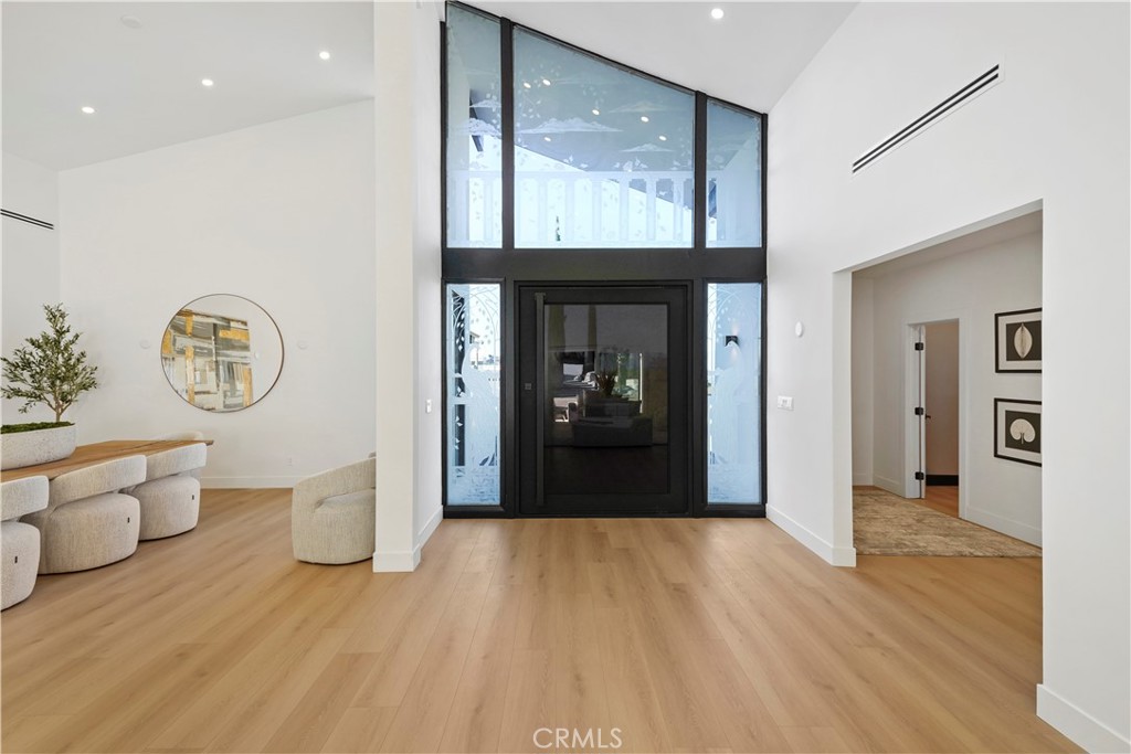 Welcome to this meticulously renovated home, located in one of the most sought-after neighborhoods in Encino. Designed to meet the demands of today’s lifestyle, this home seamlessly blends elegance, comfort, and modern luxury.
With a spacious open floor plan, this home offers an abundance of natural light, creating an inviting and airy atmosphere. The 18-foot high ceilings and recessed lighting elevate the design, while the seamless flow between indoor and outdoor spaces makes it perfect for entertaining or relaxation.
The chef-inspired kitchen is a true masterpiece, featuring custom-built cabinets, sleek black diamond leathered countertops, and high-end stainless steel appliances. Whether preparing a family meal or hosting guests, this kitchen is built for both style and function.
The outdoor space is equally impressive, offering a private oasis with a pool, spa and multiple seating areas, ideal for unwinding or enjoying family gatherings. The primary suite is a luxurious haven, providing ample space, privacy, and comfort, with an atmosphere of serene sophistication.
This home is more than just a property—it's a lifestyle. Offering a rare combination of timeless design, top-tier finishes, and an ideal location in one of Encino’s most prestigious Lake Encino community, this is truly a one-of-a-kind opportunity.