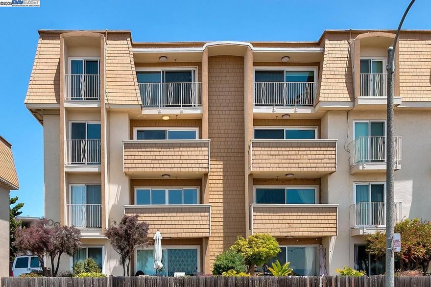 Watch the windsurfers glide by from your living room in this stunning end-unit condo just steps from the shoreline. This light-filled 2-bedroom, 2-bath home offers breathtaking bay and city views in a secured building. Freshly updated with new LVP flooring throughout, new baseboards, and crisp interior paint, the space feels fresh and inviting. Natural light pours in through four sliding glass doors and expansive windows, creating a bright and airy atmosphere. The kitchen features granite countertops, newer cabinets, and a brand-new range/oven—ideal for both everyday meals and entertaining. Enjoy two spacious bathrooms, convenient in-unit laundry, and a detached 1-car garage with access to additional community storage and an EV Charger on property. Whether you are an investor or end user this home is perfectly located near Robert W. Crown Memorial State Beach, picnic areas, a dog park, and miles of walking and biking trails- coastal living at its best!