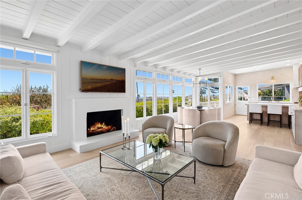 A rare turnkey opportunity in North Laguna Beach, this 3-bedroom, 3-bathroom residence offers 1,766 sq.ft. of refined coastal living. Completely upgraded in 2025, the home combines timeless design with modern sophistication. The chef’s kitchen showcases custom white oak cabinetry, Taj Mahal leathered quartzite countertops, a brick backsplash, and top-of-the-line Thermador appliances. The spa-like bathrooms feature limestone and quartzite finishes, Kohler fixtures, and a soaking tub in the primary suite. Additional upgrades include a premium HVAC with air purification, updated plumbing and sewer lines, engineered white oak flooring, motorized blinds, custom fireplace, and refreshed landscaping. Perfectly situated in the heart of North Laguna, this property offers a rare blend of timeless design, modern upgrades, proximity to the best beaches, where art, dining, and coastal charm define the Laguna Beach lifestyle.