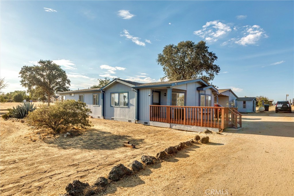 Tucked away at the end of the road in the heart of Paso Robles wine country, this charming home offers space, comfort, and privacy just minutes from downtown and local attractions. Step inside to find 3-bedrooms, 2-baths, vaulted ceilings and a welcoming layout with both a family room and living room. The formal dining room features a built-in hutch, while the kitchen is designed for convenience with ample cabinetry, a breakfast bar, and an organized swing-out pantry shelving system. New flooring throughout and freshly painted.
The primary suite includes a great sitting area or office space, a walk-in closet, dual sinks, a relaxing garden tub, and a separate shower. Enjoy the fresh country air on the front deck or entertain on the larger back deck overlooking your 3-acre property. The land is flat and fully usable. Along the westerly acre, three pastures are partitioned with water available at each. There is an additional fenced space near the home, ideal for animals or gardening.
Additional structures include a barn with a metal roof, various outbuildings for storage and equipment, plus a carport attached to a large, finished storage room with power connected, and double doors for easy access. Includes RV hookups with power, water, and a cleanout. Mature oak trees, shade trees, and privacy hedges create a peaceful, secluded setting with beautiful vineyard views. The property is perimeter fenced and accessed via paved road up to a short unpaved stretch at the house.
A recently recorded permanent foundation streamlines the financing options for this home. This property is ready to welcome its next owner to the relaxed Paso Robles lifestyle! Just a short distance to town, or to event locations including the Vina Robles Amphitheatre, Paso Robles Equestrian Park, Ravine Water Park, Sensorio, and many other local venues and attractions!